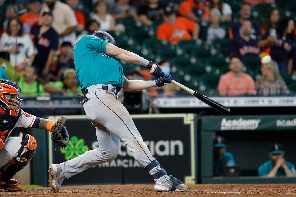 Seattle Mariners' Abraham Toro, left, scores past Los Angeles