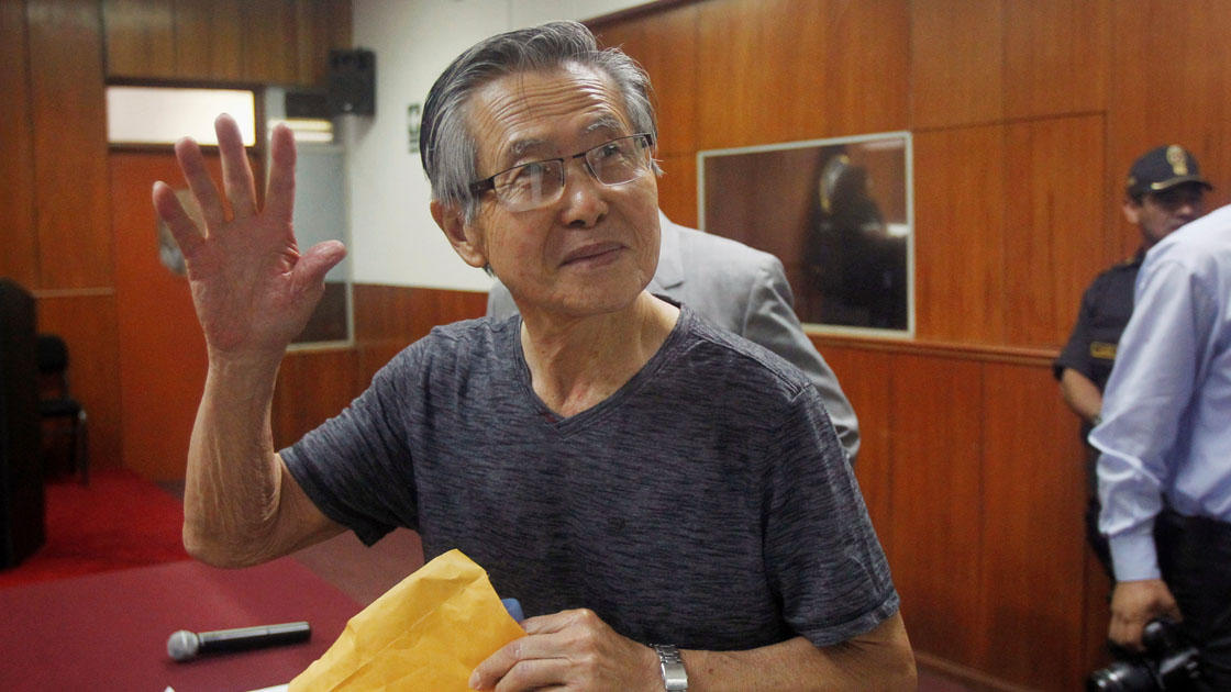 FILE PHOTO: Peru's former President Alberto Fujimori waves to the media as he arrives in court for the sentencing in his trial in Lima