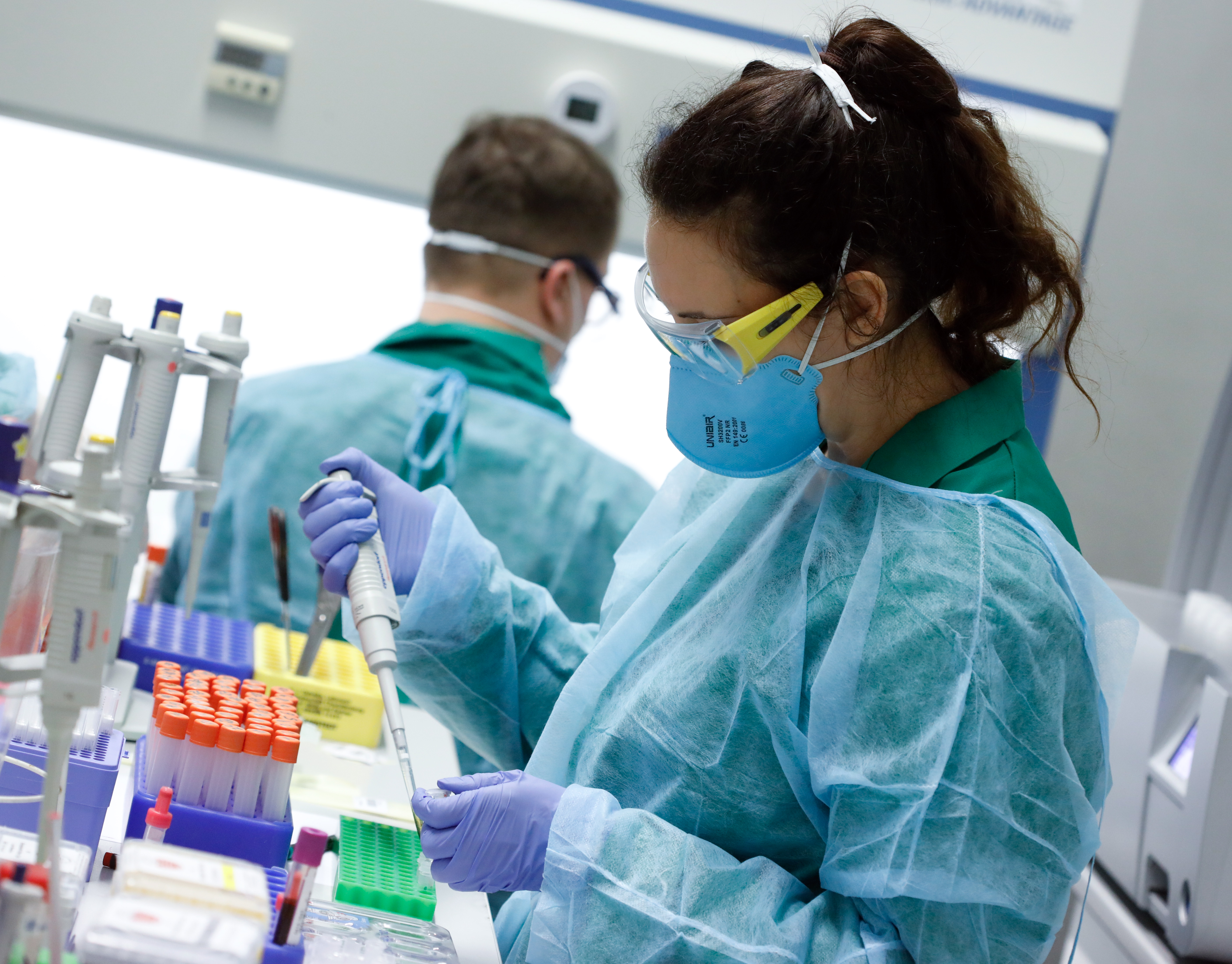 Employees in protective clothing do testings for the corona virus at a laboratory in Berlin, Germany, March 26, 2020, as the spread of the coronavirus disease (COVID-19) continues. REUTERS/Axel Schmidt