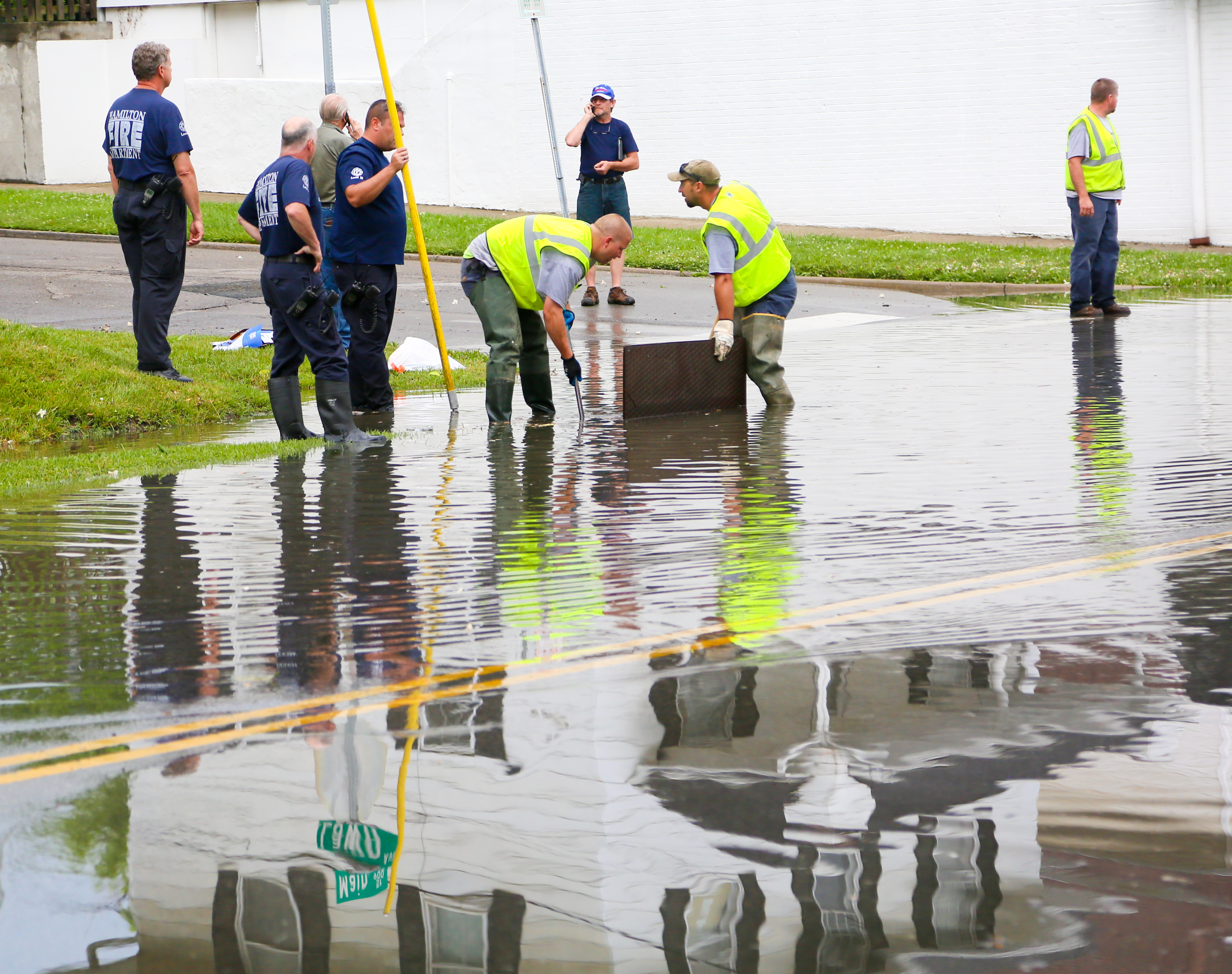In June 2016, Hamilton city crews worked to clear drains in the flooded areas of Main Street on the west side of Hamilton after heavy rain and flash flooding.