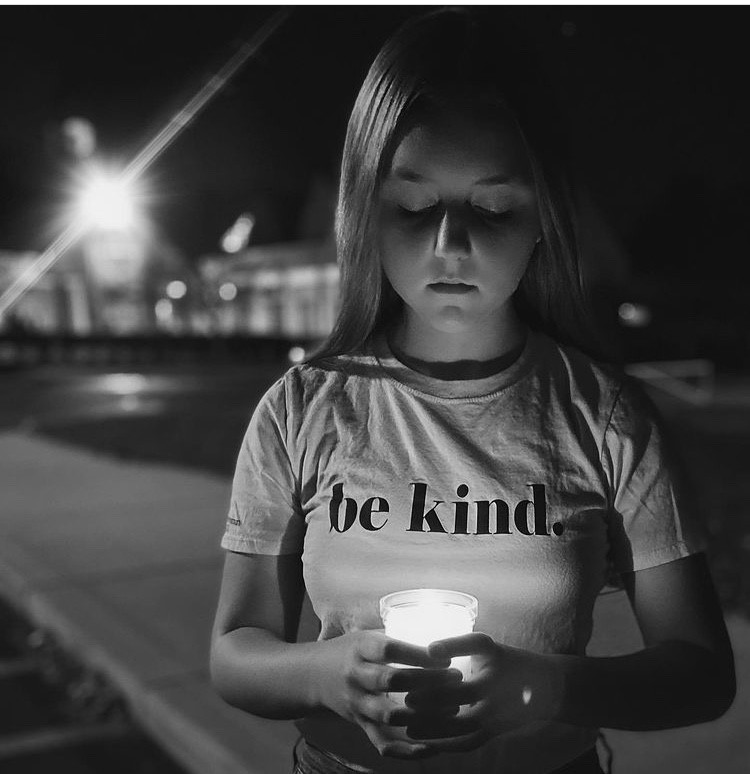 Reese Hornick holding a candle outside a memorial Mass at St. Charles Borromeo in November 2020 (the Mass they have every year to honor those who were lost in the past year). Contributed photo
