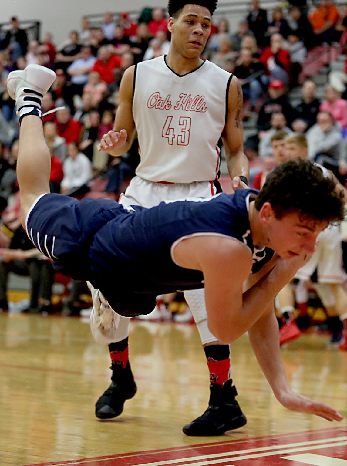 Oak Hills guard Ryan Batte watches Edgewood guard Nick Noble fly out of bounds during their Division I sectional contest at Fairfield Arena on Tuesday night. CONTRIBUTED PHOTO BY E.L. HUBBARD