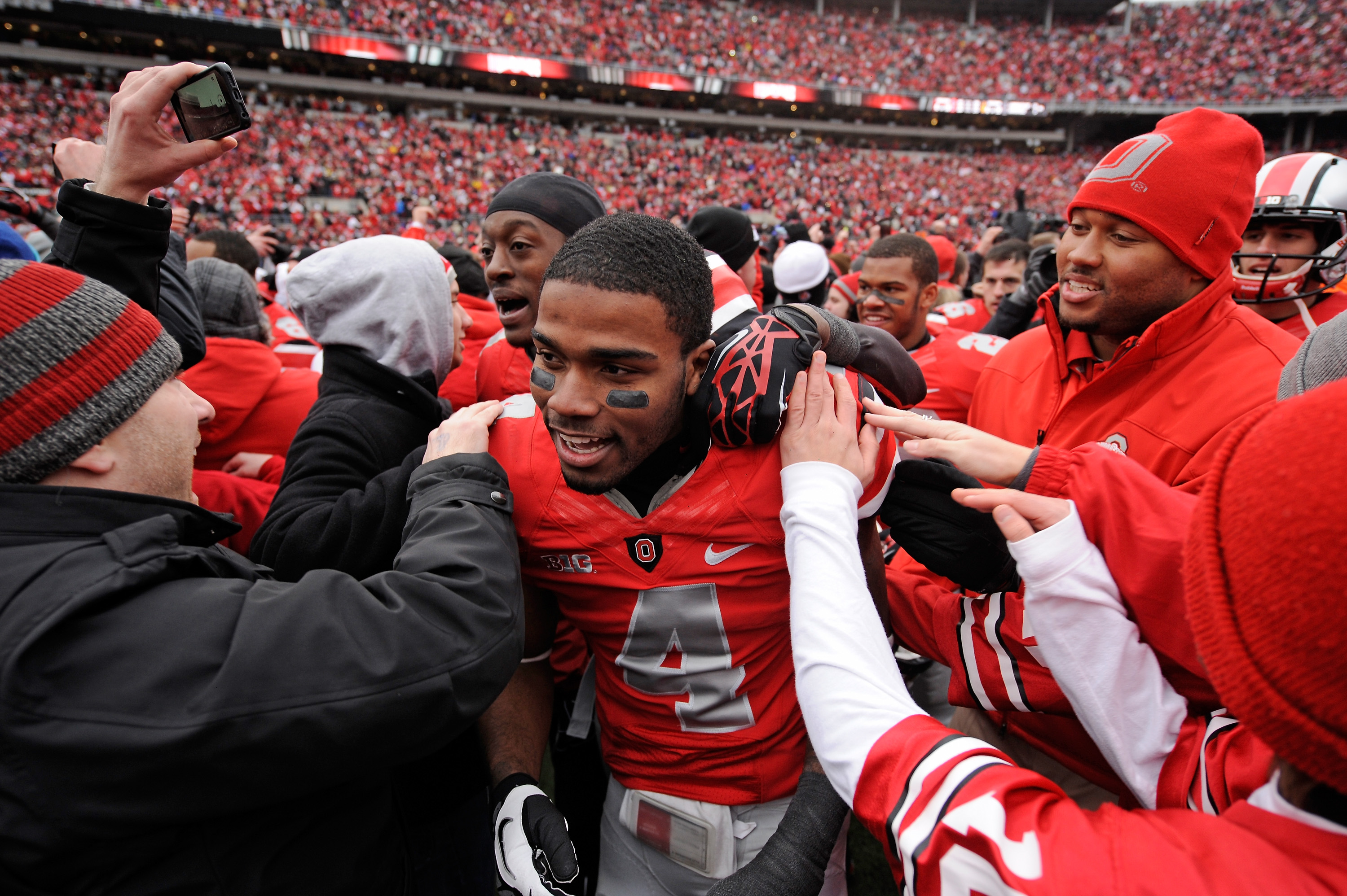 COLUMBUS, OH - NOVEMBER 24: C.J. Barnett #4 of the Ohio State Buckeyes is congratulated by fans after Ohio State defeated the Michigan Wolverines 26-21 at Ohio Stadium on November 24, 2012 in Columbus, Ohio. (Photo by Jamie Sabau/Getty Images)