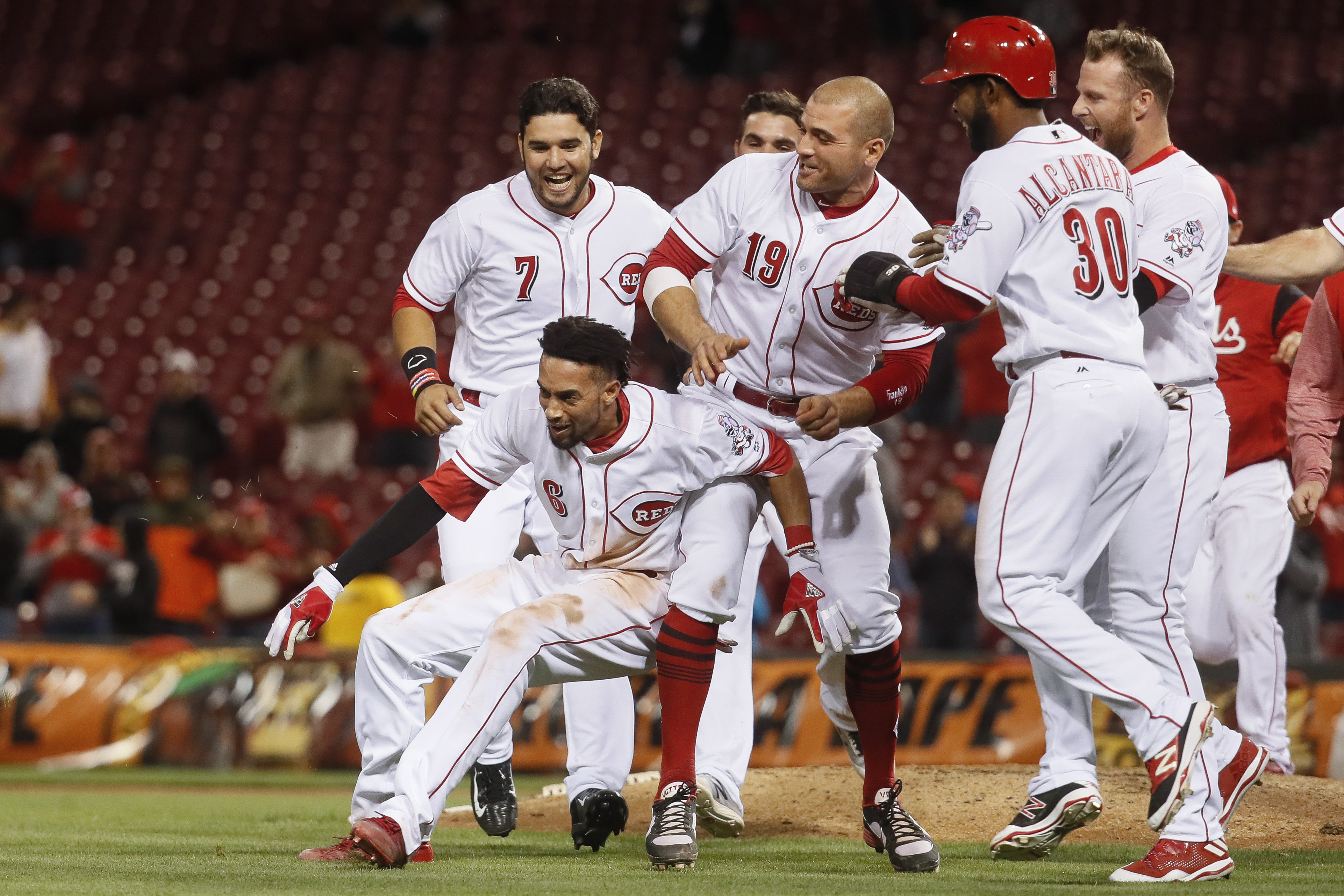 Cincinnati Reds’ Billy Hamilton (6) celebrates with Joey Votto (19) after hitting the game-winning RBI single in the 10th inning of a baseball game, Monday, May 1, 2017, in Cincinnati. The Reds won 4-3. (AP Photo/John Minchillo)