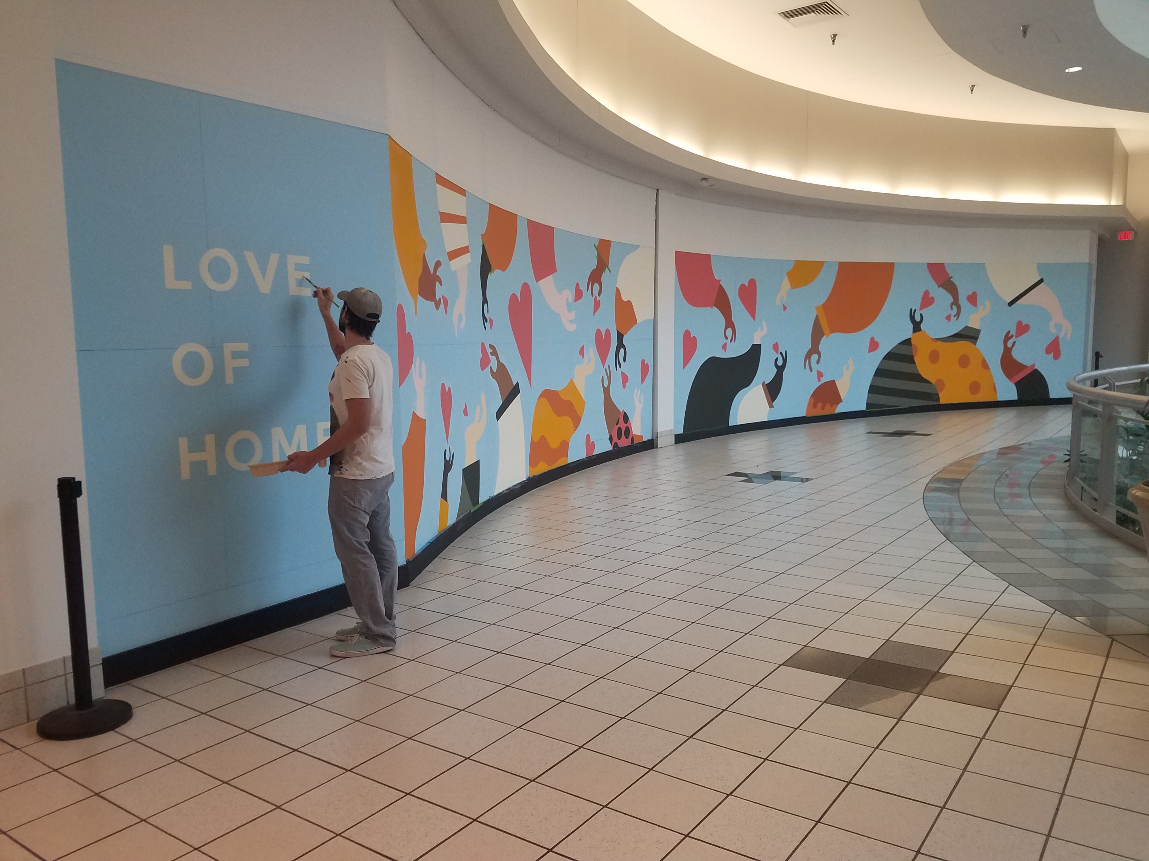 A new mural at the Dayton Mall, "Love of Home," is hoping to inspire residents of Dayton to give love after the tragedies of the previous year.