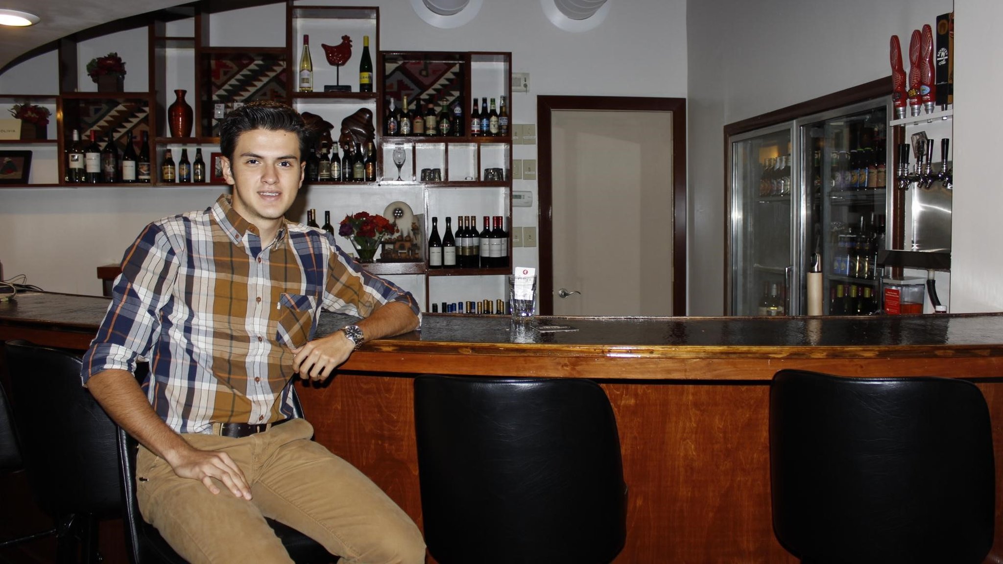 Cesar Santillan, nephew of co-owner Rafael Santillan, sits at the bar at Nelly’s restaurant, 79 S. Main St. Centerville. CONTRIBUTED