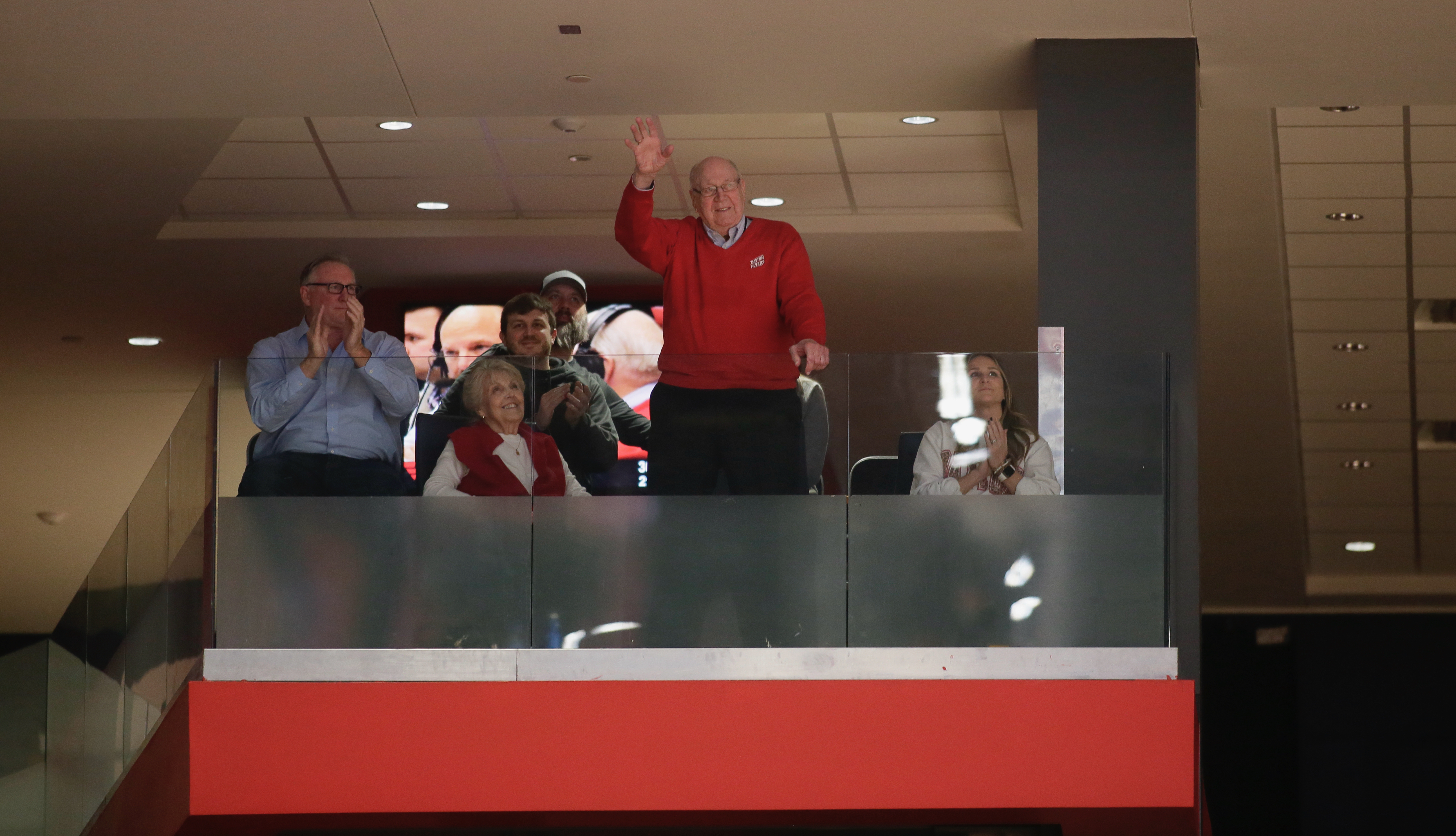 Dayton basketball legend Bucky Bockhorn waves to the crowd after being honored during a game between Dayton and St. Bonaventure on Tuesday, Jan. 18, 2022, at UD Arena.