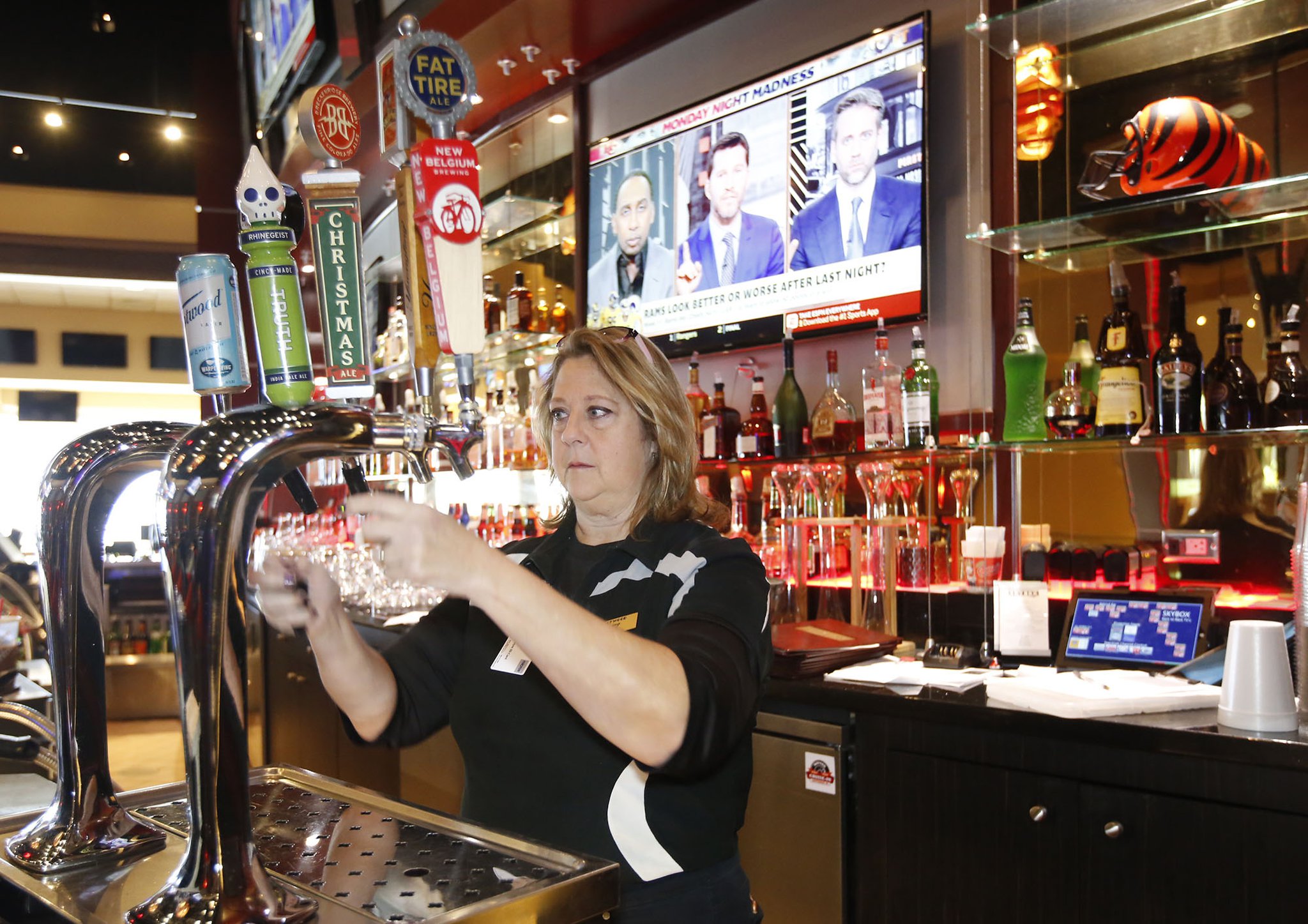 Hollywood Gaming employee Lois Cross prepares the beer taps for lunch customers. Casinos and racinos in Ohio have not produced the revenue projected by the gaming industry when voters allowed the businesses to open in the state, but numbers have held steady and grown since 2012 when the first was opened. The eleven venues in Ohio generated nearly $1.6 billion in revenue between January and October of 2018 according to the UNLV Center for Gaming Research. TY GREENLEES / STAFF