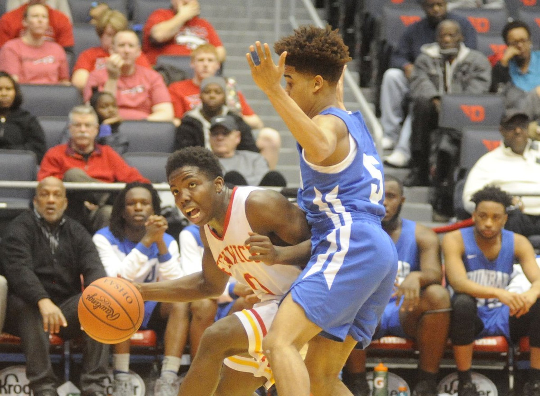 Fenwick’s Caleb Davis (0) tries to drive past Kadar Gardner (5) of Dunbar during Wednesday night’s Division II sectional final at the University of Dayton Arena. MARC PENDLETON/STAFF