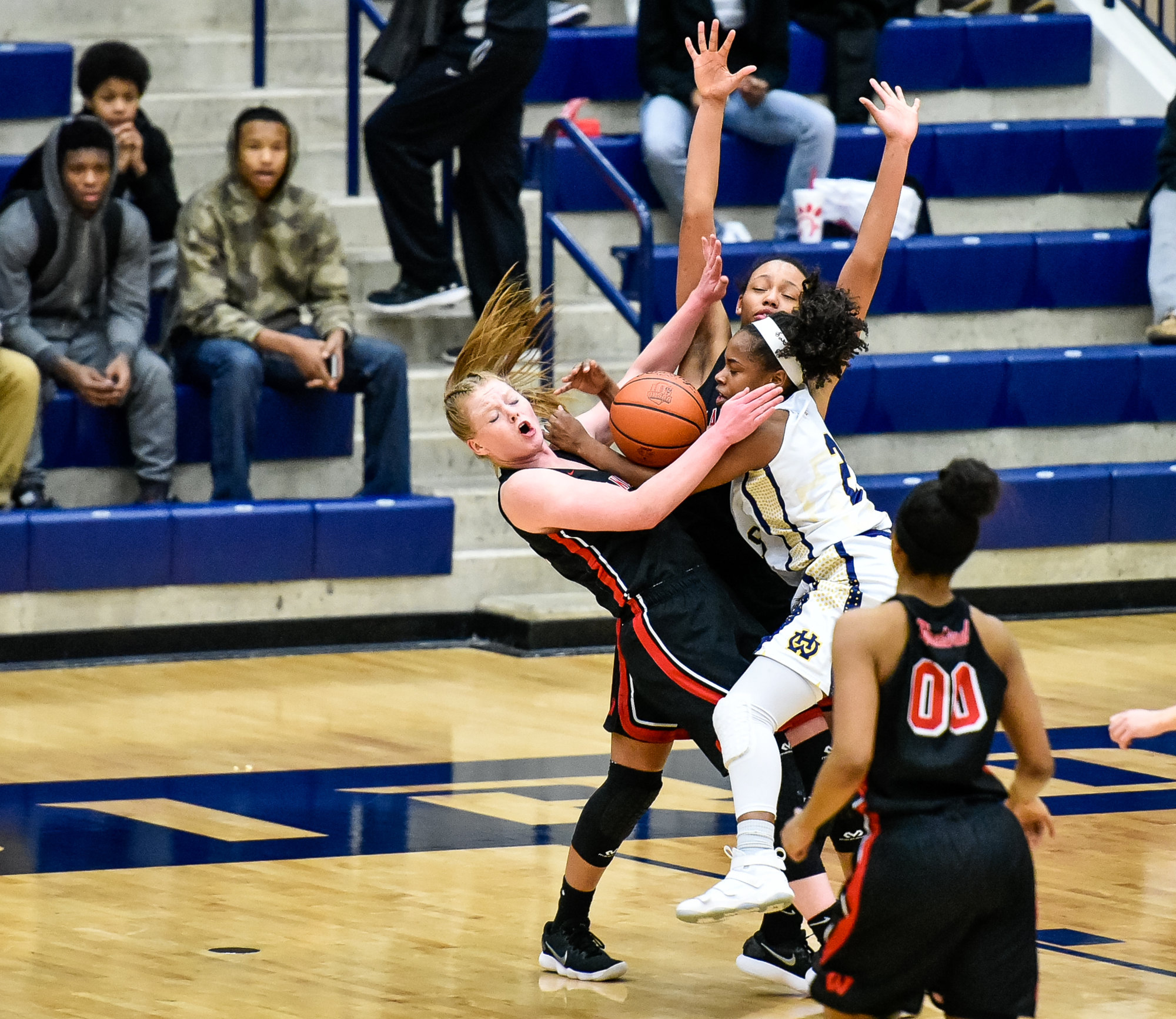Lakota West's Abby Prohaska is fouled by Walnut Hills' Regan Anderson during their Division I regional semifinal Wednesday night at Fairmont’s Trent Arena. NICK GRAHAM/STAFF