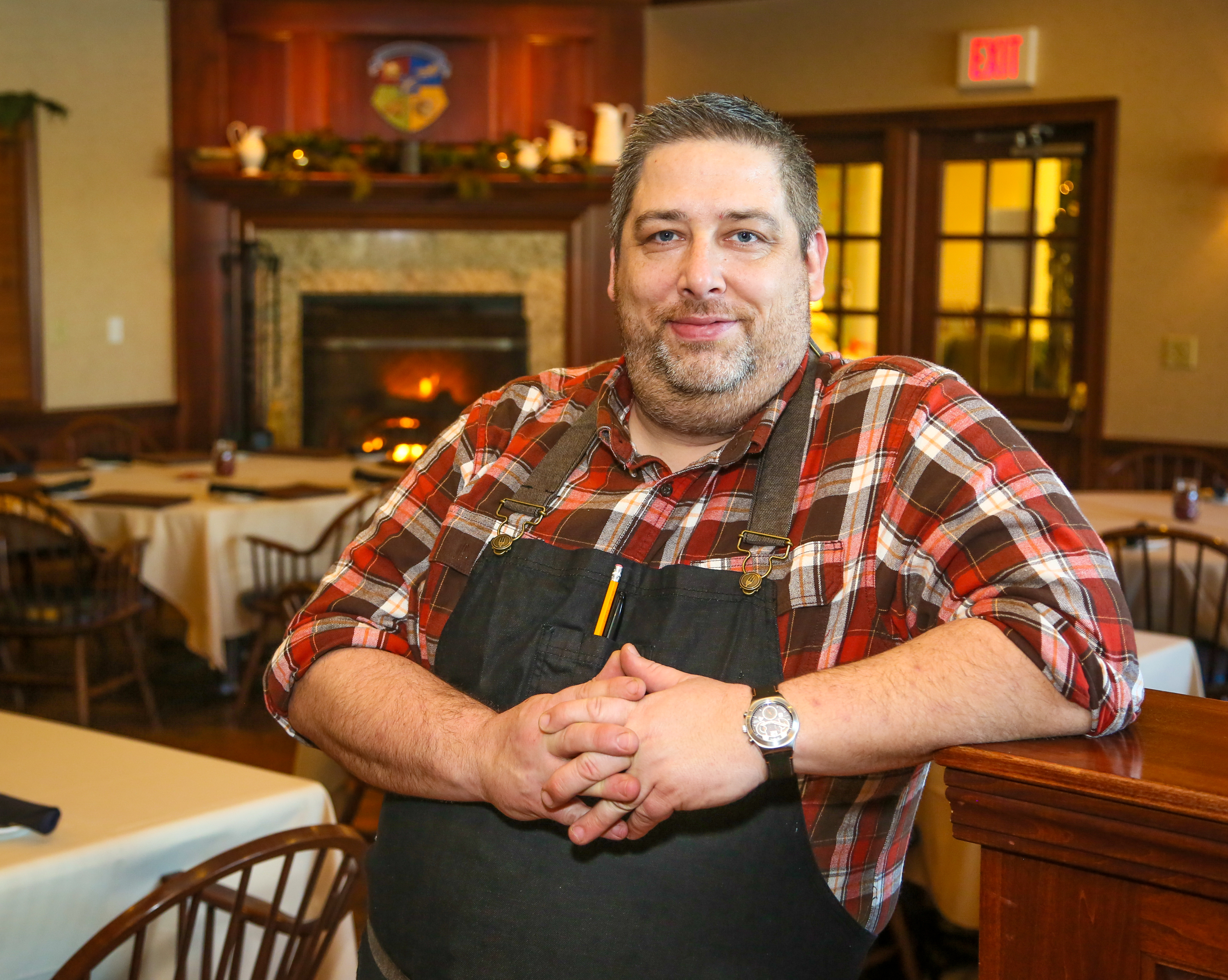 Jared Whalen, executive chef of the Coach House, stands in the dining room of the tavern and grill, Thursday, Dec. 15. The Coach House became a public restaurant this year after previously being a members-only establishment. GREG LYNCH / STAFF