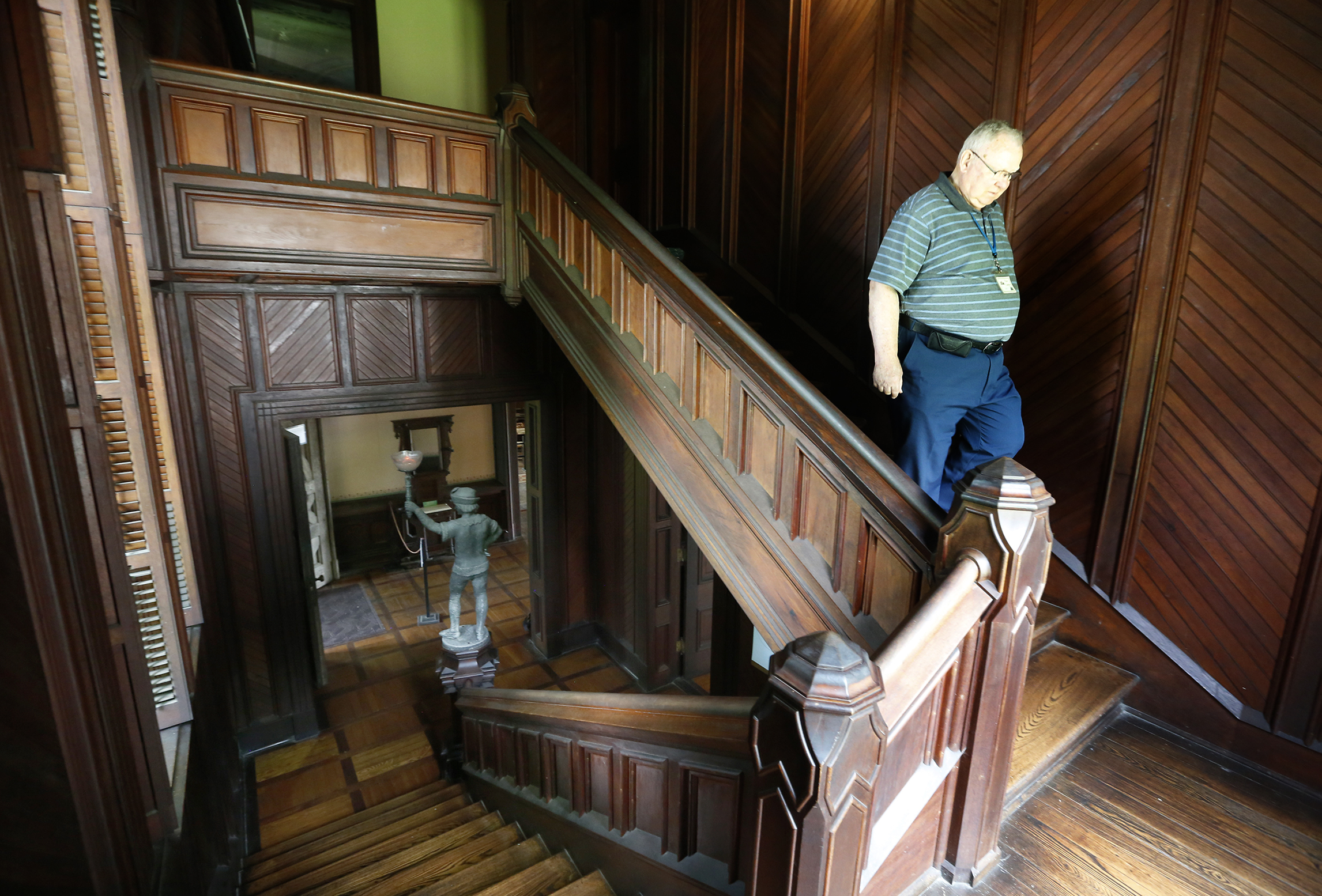 Jim Heiser, an interpretor at the Piatt Castles for 14-years, descends a staircase at Mac-O-Chee. The home was constructed in two sections beginning in the 1860s and completed in the 1880s. LISA POWELL / STAFF