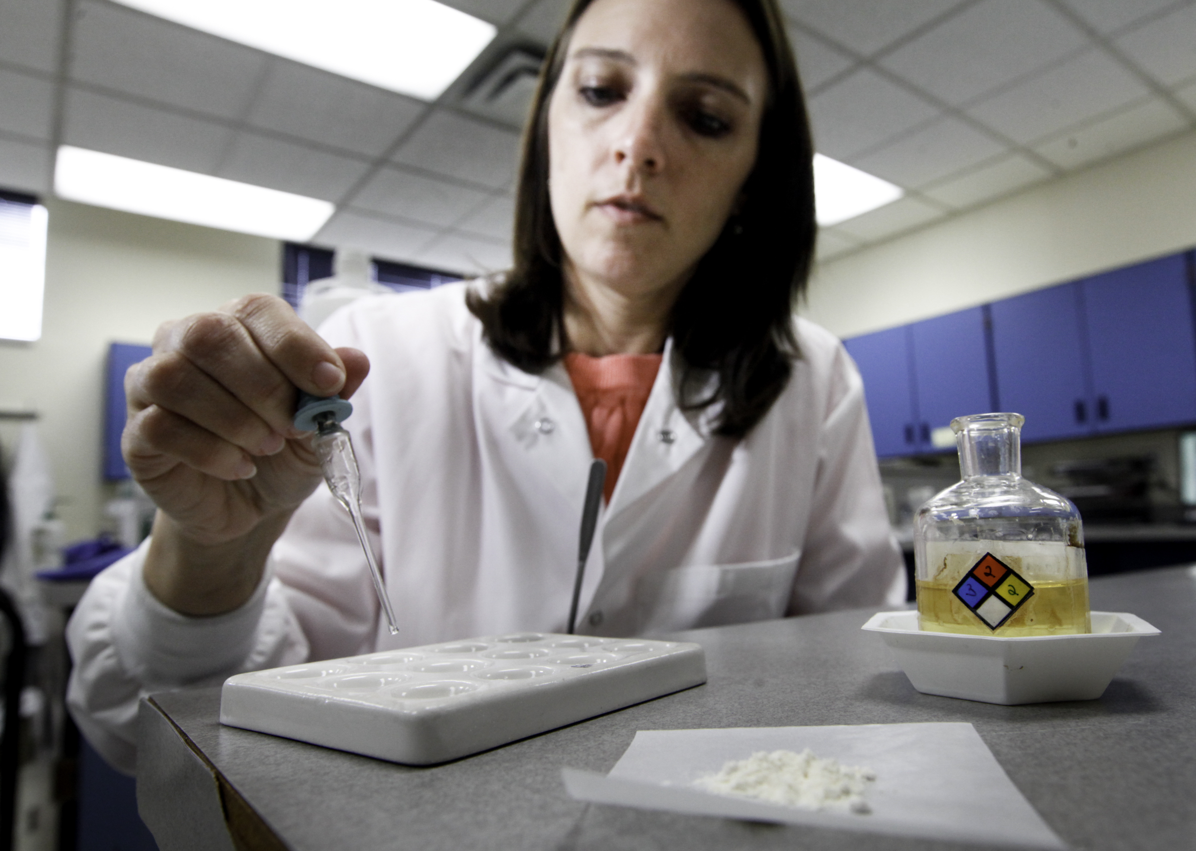 Brooke Ehlers, technical leader of the Miami Valley Regional Crime Laboratory's Chemistry Section, tests a drug sample for fentanyl. The highly potent synthetic opioid -- often cut with heroin or used alone -- has been on the streets for more than a year in the Dayton area and is responsible for an increasing number of overdose deaths. CHRIS STEWART / STAFF
