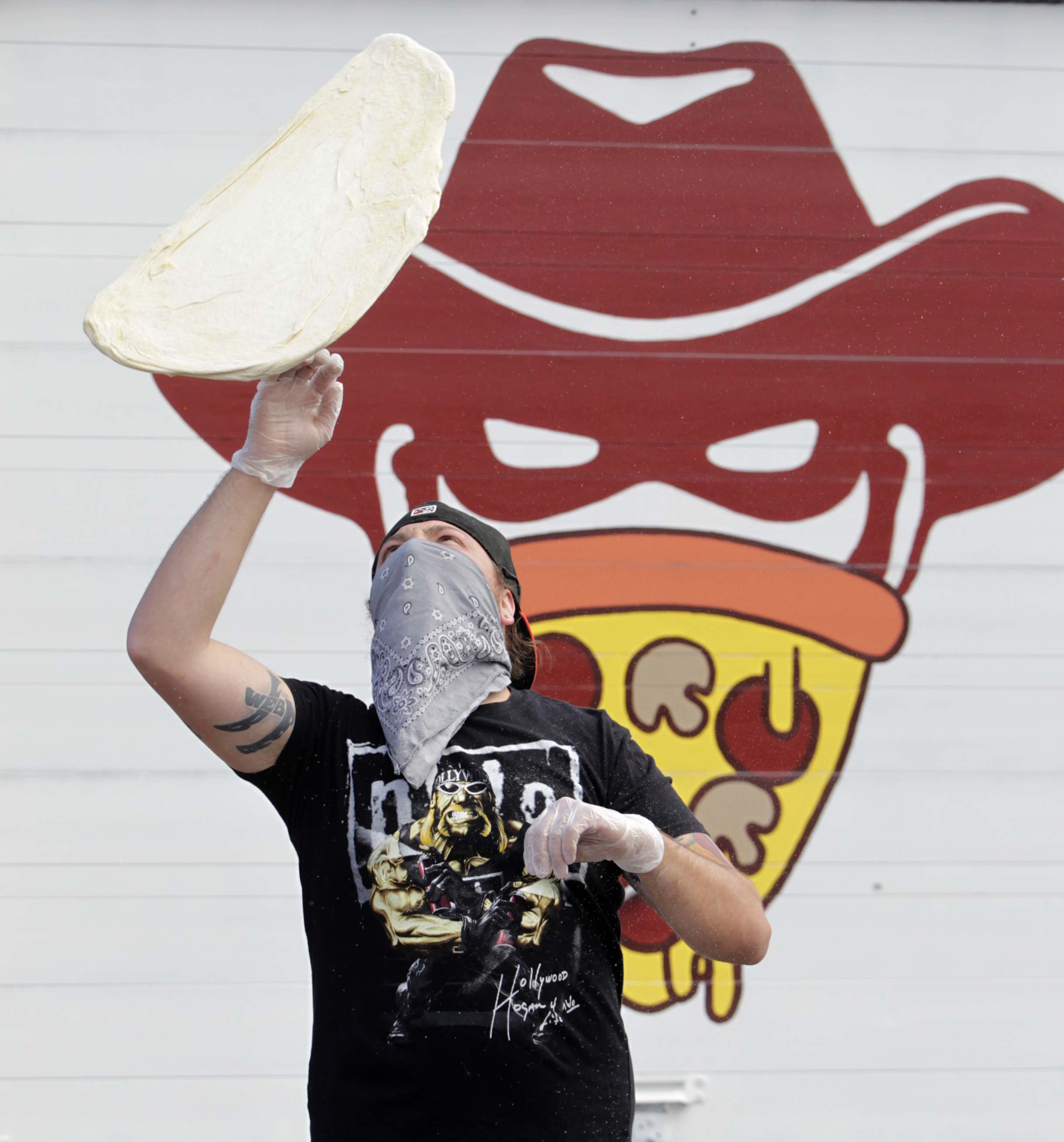 James Burton is one of the owners of The Pizza Bandit, a New York style pizza truck that can be found at the Yellow Cab Tavern in Dayton. LISA POWELL / STAFF