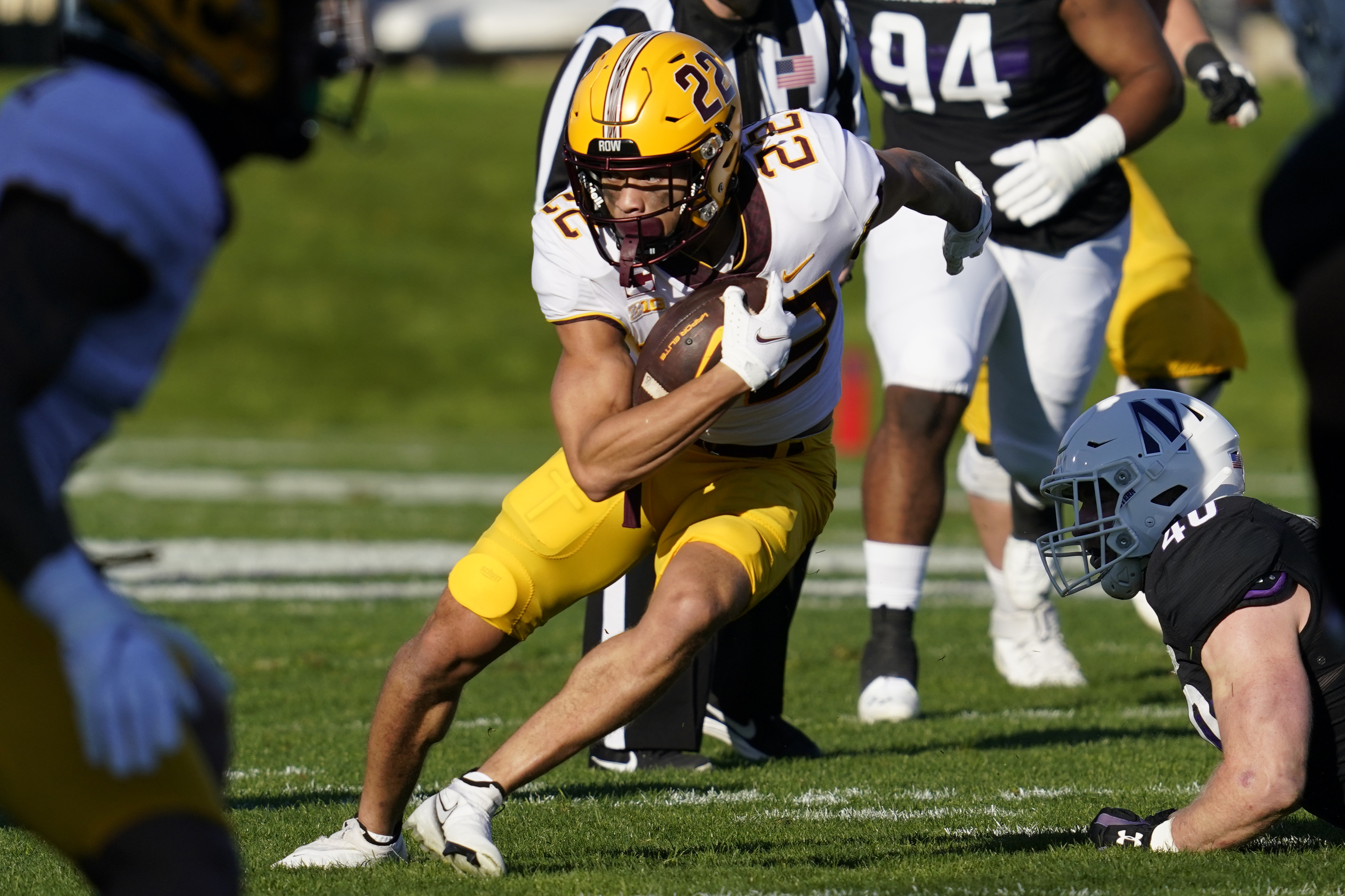 Minnesota wide receiver Mike Brown-Stephens (22) runs with the ball past Northwestern linebacker Peter McIntyre (40) during the first half of an NCAA college football game in Evanston, Ill., Saturday, Oct. 30, 2021. (AP Photo/Nam Y. Huh)