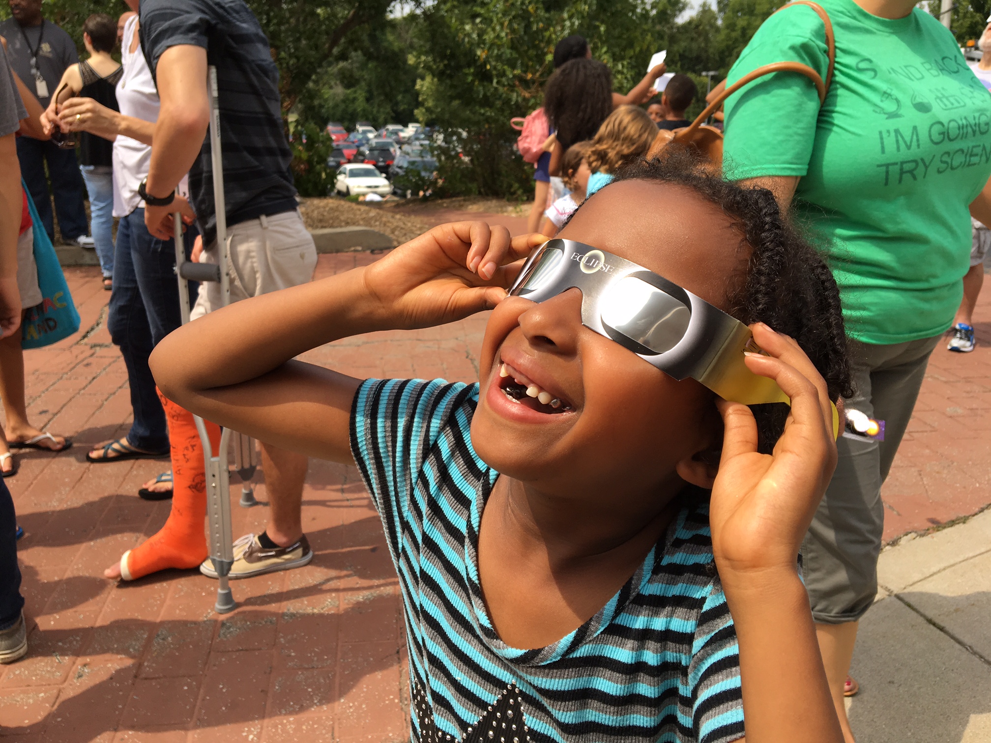 Zoe Negassi, 7, of Beavercreek watches her first solar eclipse Monday at the Boonshoft Museum of Discovery. CHRIS STEWART / STAFF