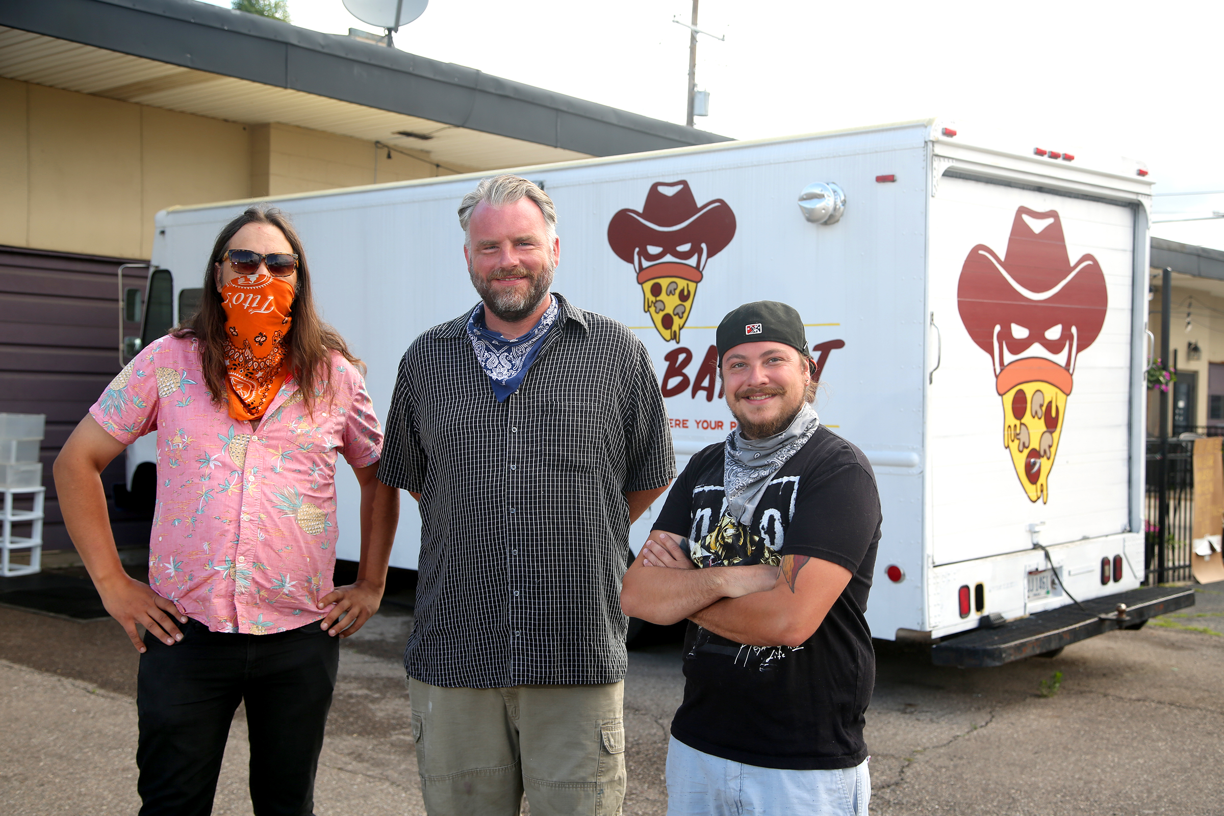 Brian Johnson, Mark Jeffers and James Burton (left to right) are the owners of the Pizza Bandit, a New York style pizza truck that can found at the Yellow Cab Tavern in Dayton. LISA POWELL / STAFF