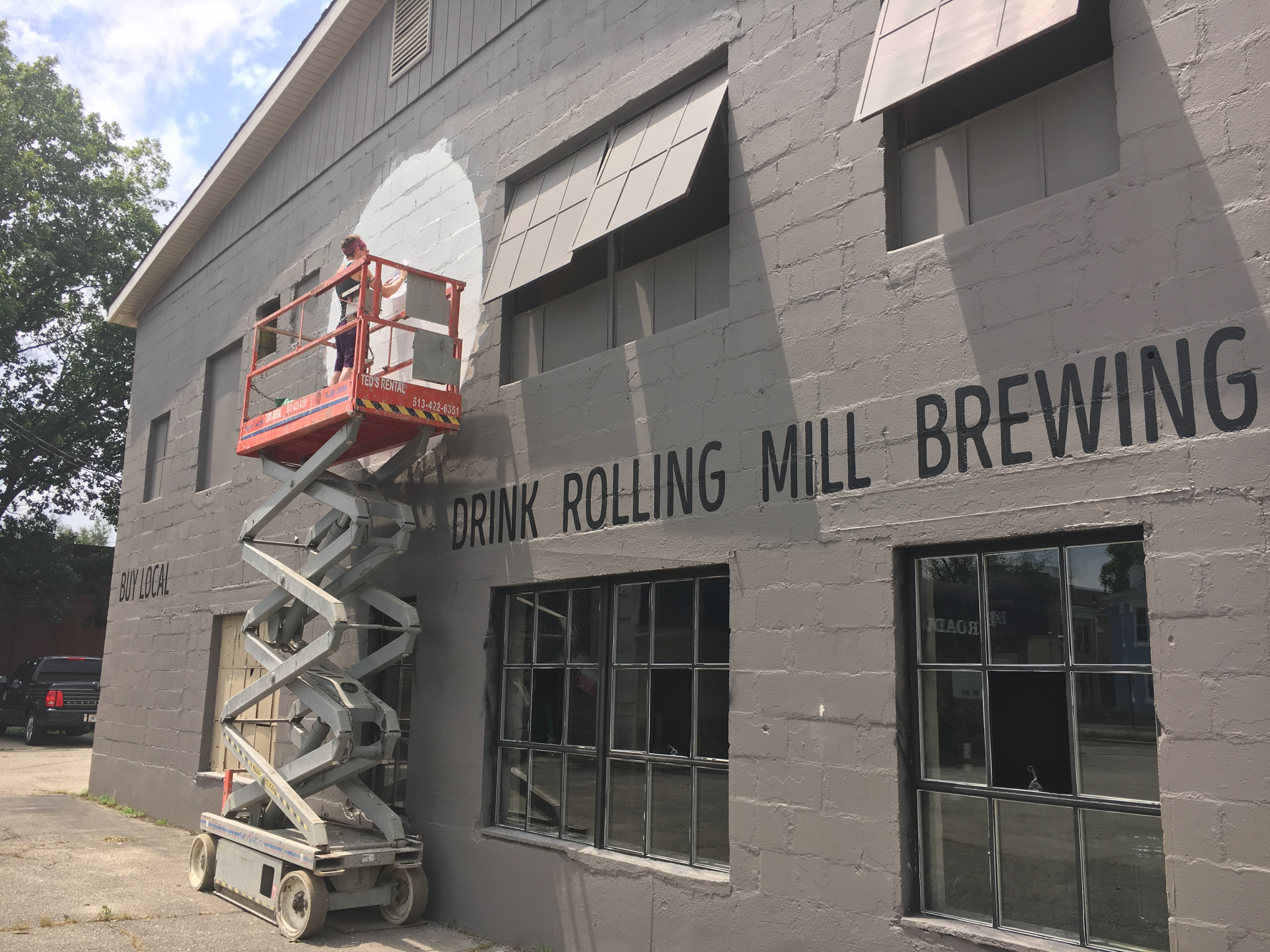 Jennifer Morrell paints the outside of Rolling Mill Brewing Company in July. Middletown’s new brew house is set to make its debut Friday, Dec. 22, at 916 1st Ave.