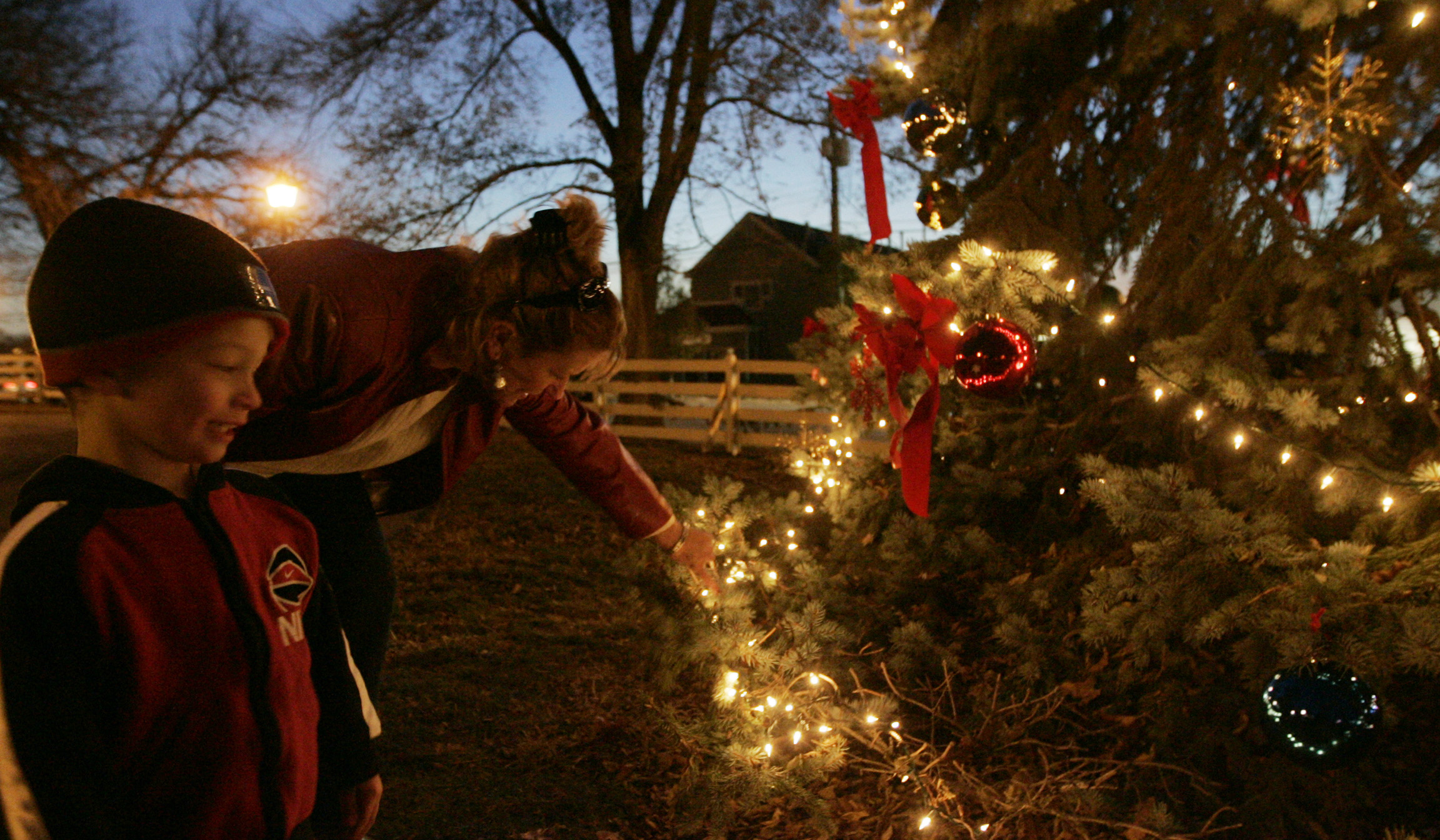 Aiden Brown, 3yrs old, looks over the Christmas tree, in Benham's Grove, with his grandmother, Kelley Brown. They were attending the official Centerville tree lighting in the park.