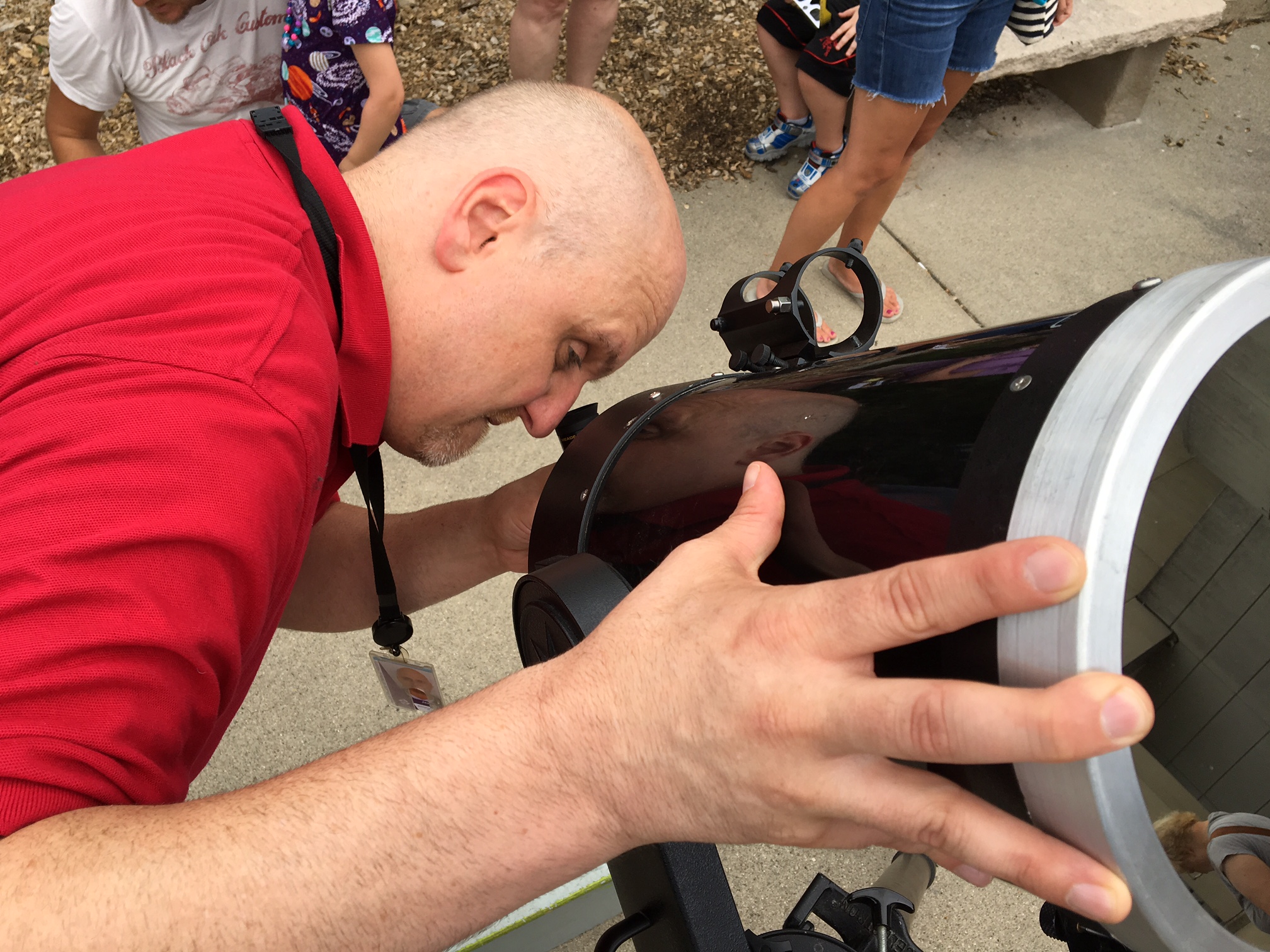 Jason Heaton, the Boonshoft Museum of Discovery's director of astronomy, lines up a telescope for solar eclipse viewers Monday at the Dayton museum. CHRIS STEWART / STAFF