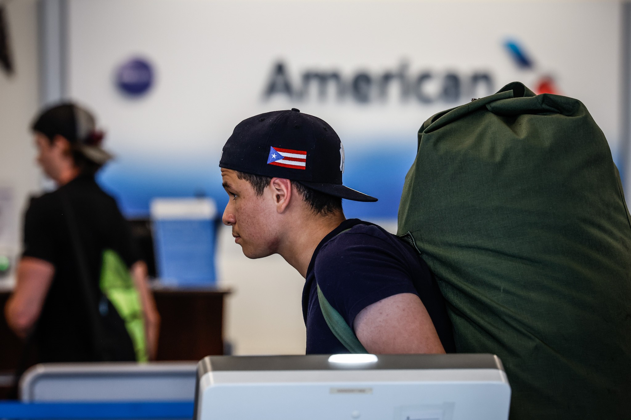 Pedro Figueroa, from the Bronx in New York City, waits inline at American Airlines ticket counter at the Dayton International Airport Friday July 15, 2022. JIM NOELKER / STAFF