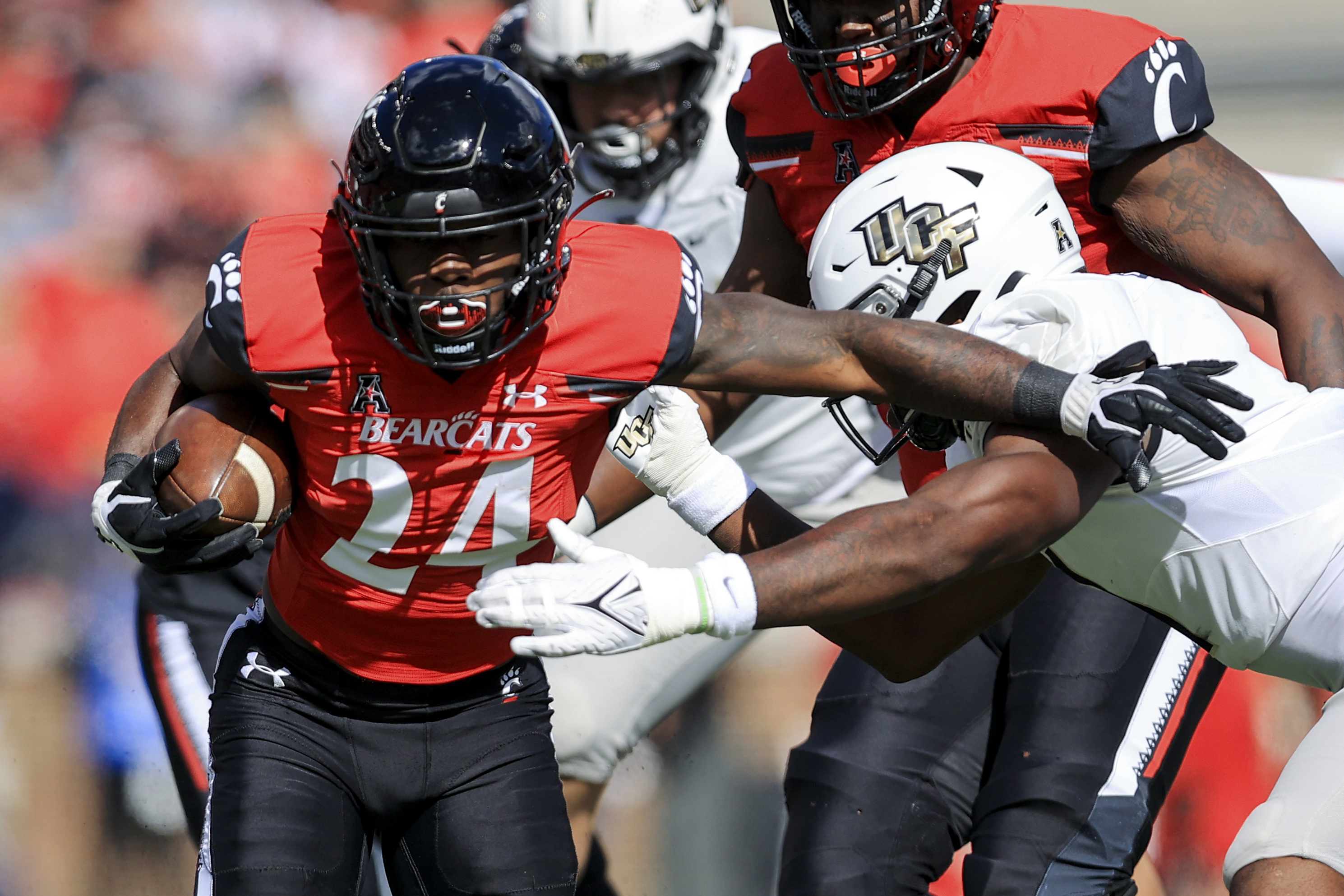 No, Cincinnati Bearcats will not play on a black football field Friday