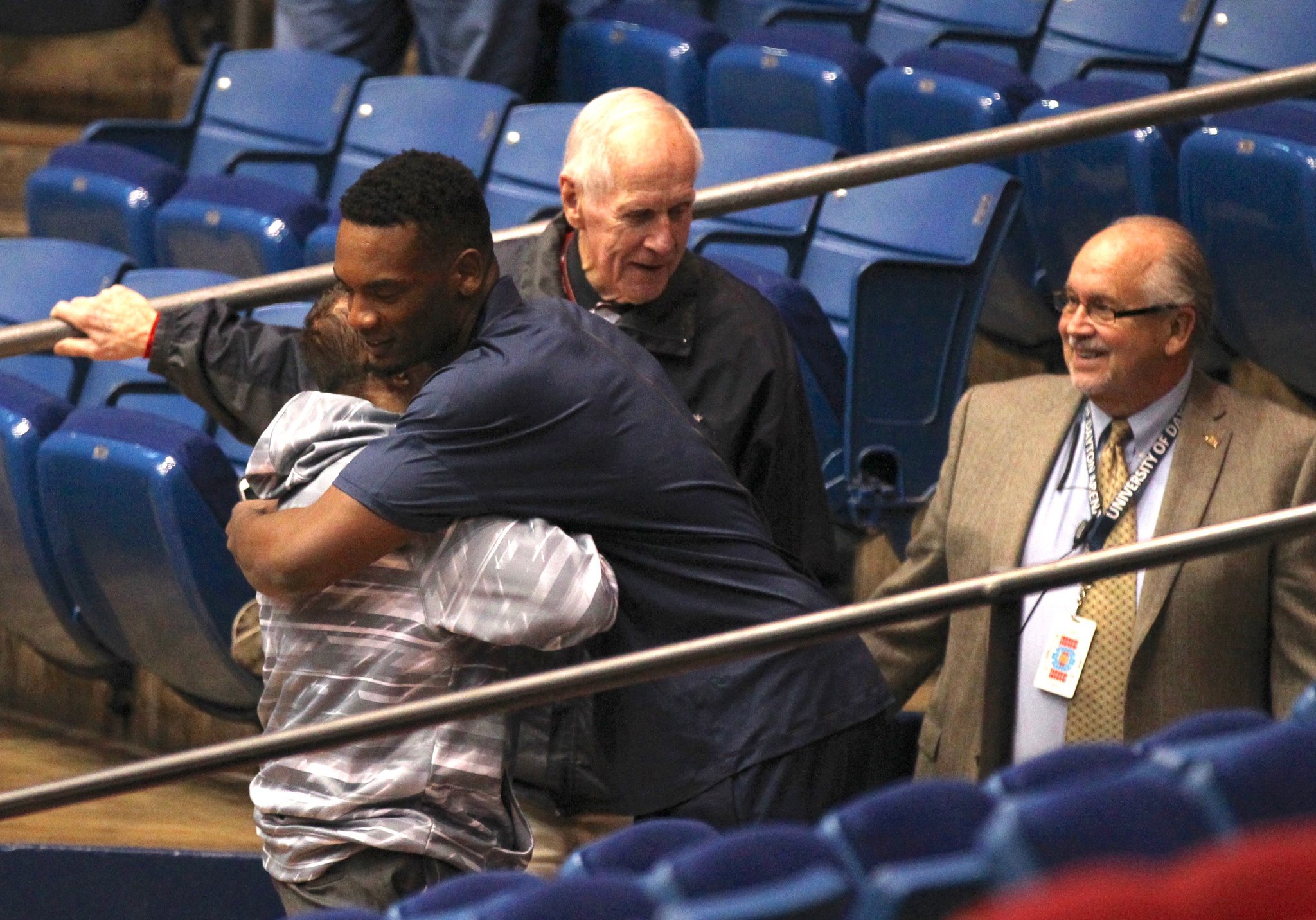 Dayton's Dyshawn Pierre hugs Dr.  Stephen Levitt before a game against Miami on Tuesday, Dec.  22, 2015, at UD Arena in Dayton.  DAVID JABLONSKI |  STAFF