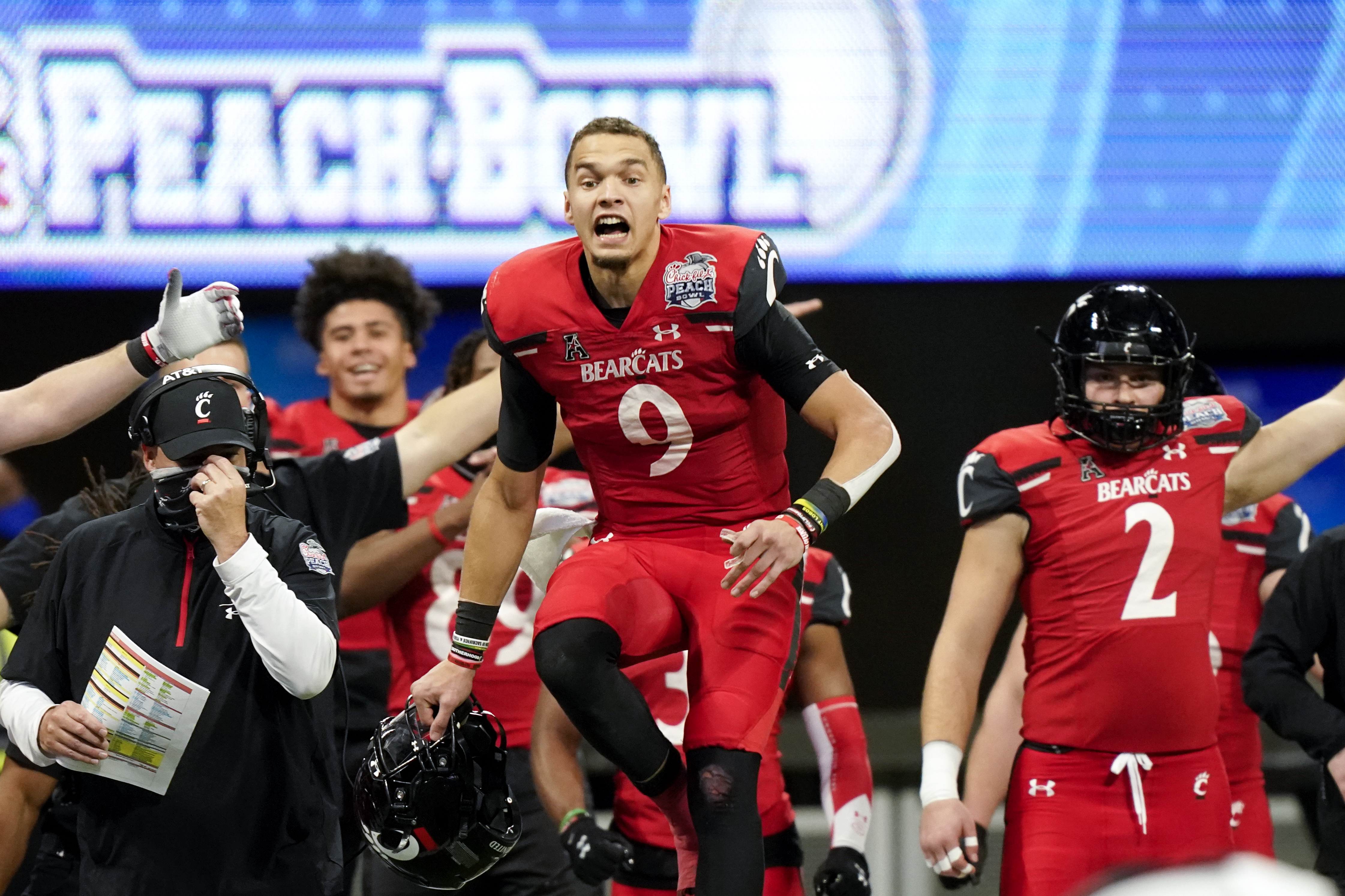 Cincinnati quarterback Desmond Ridder (9) reacts to a Georgia fumble during the second half of the Peach Bowl NCAA college football game, Friday, Jan. 1, 2021, in Atlanta. (AP Photo/Brynn Anderson)