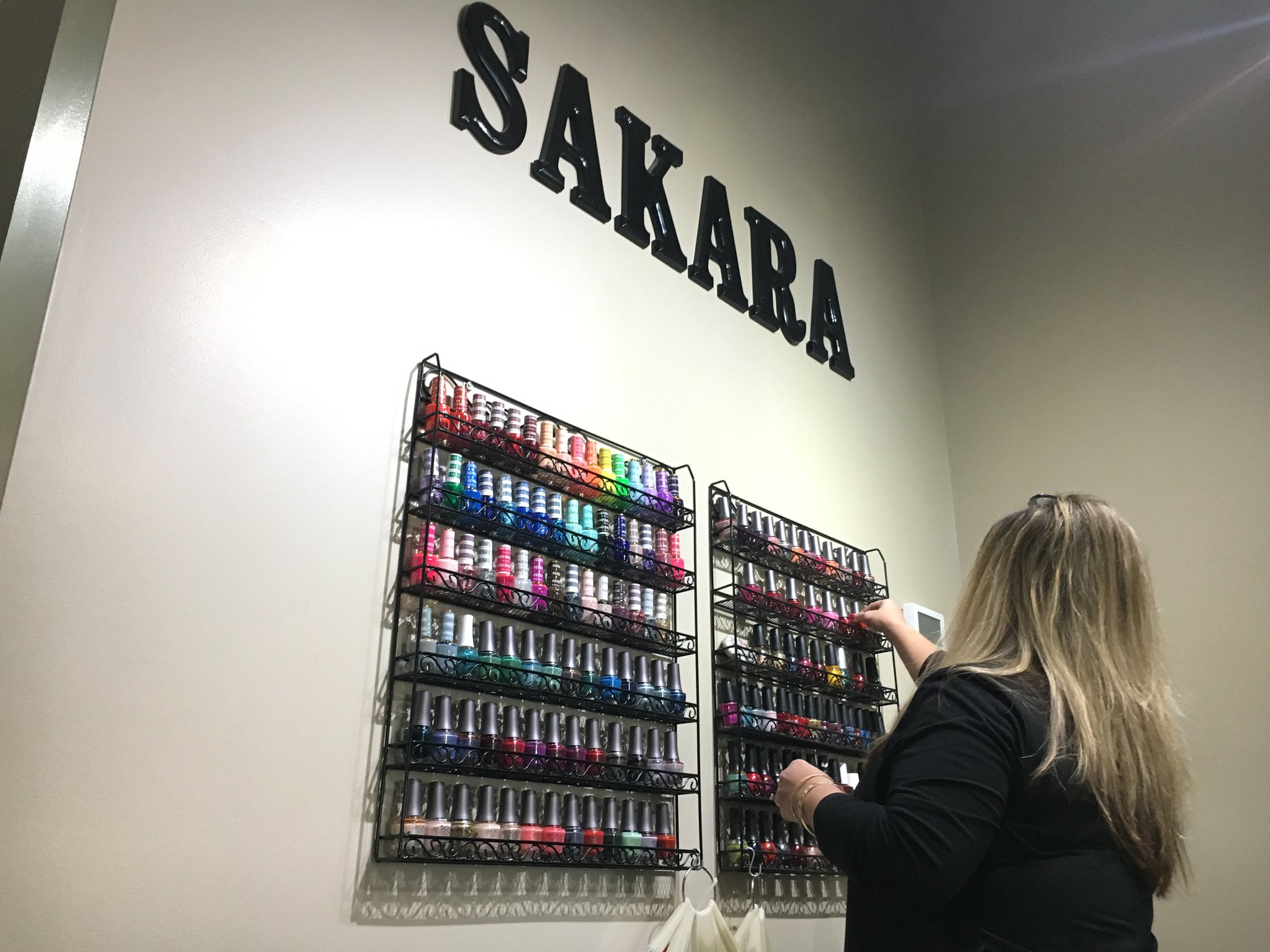 Four new businesses owned by women opened in downtown Miamisburg in the last year. Sakara salon co-owner Megan Castle picks nail color at the recently-opened salon. STAFF PHOTO / HOLLY SHIVELY