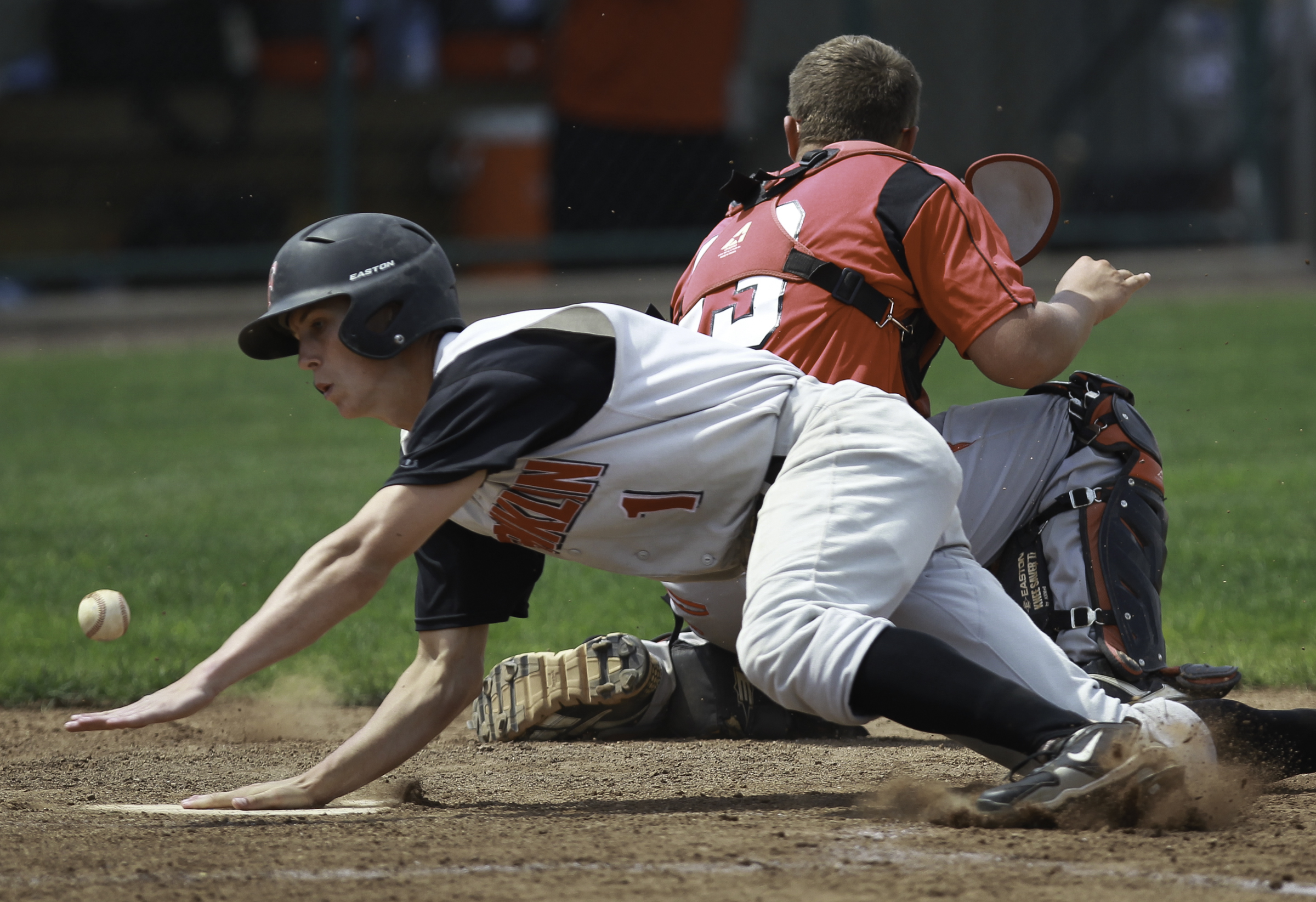 Franklin's Travis Lakins (1) makes it past Tippecanoe catcher B.J. Donathan for what would have been a game-tying fifth-inning run. Lakins was later ruled to have left the base early on a sacrifice fly. Tippecanoe held on to win 3-2 in a Division II regional baseball semifinal on Thursday, May 30 at the University of Dayton. CHRIS STEWART / STAFF