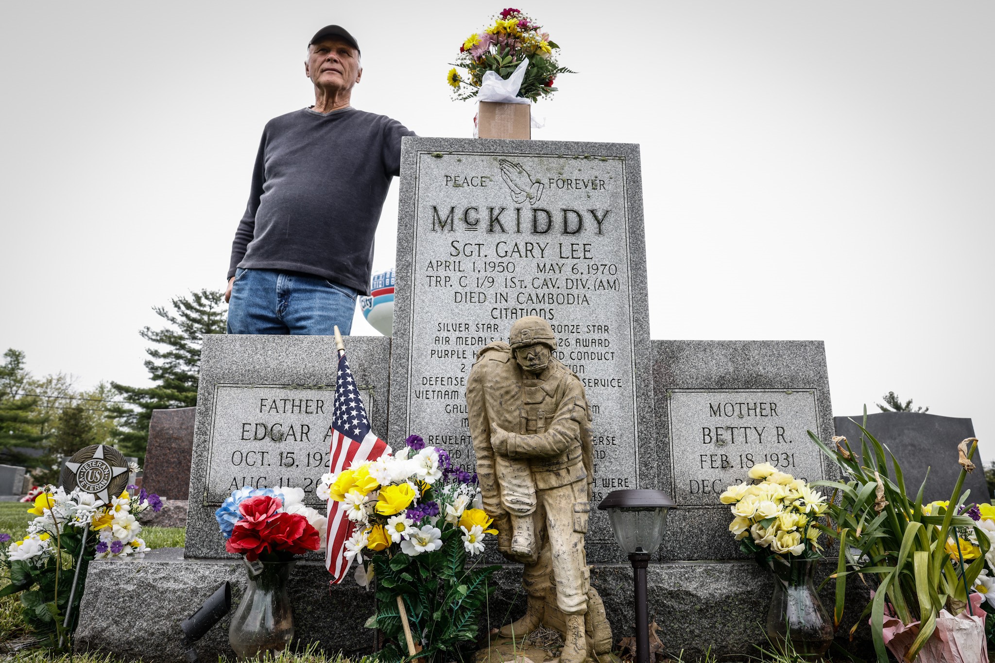 Jim Skaggs stands near the grave of Sgt. Gary McKiddy at Highland Memorial Cemetery in Miamisburg. Both men served together in Vietnam. McKiddy rescued Skaggs from a burning helicopter and died when the helicopter exploded. JIM NOELKER/STAFF