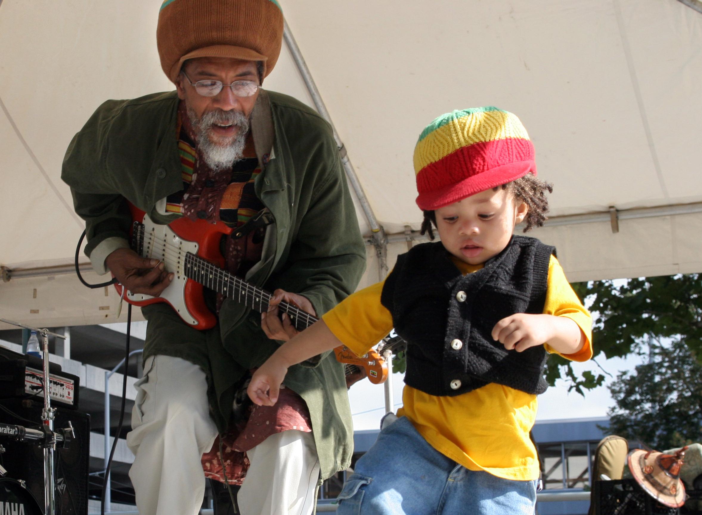 9/3/06 -- ddn090406reggaep -- Mandela Blunt, 18 months, joins Lesterfari of the Columbus band Vision on stage at the Third World Reggae Festival held at Dave Hall Plaza. Six bands worked from alternating stages to keep the music flowing throughout the day. PHOTO BY JAN UNDERWOOD