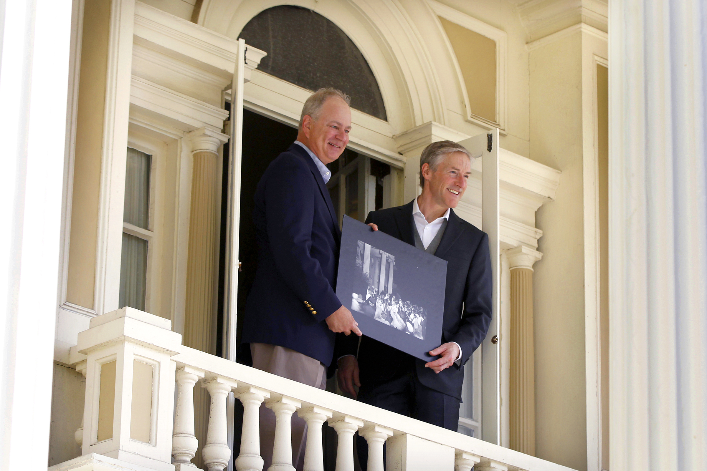 Stephen Wright, great-grandnephew of the Wright Brothers, (left) and Erik Lindbergh, grandson of famed aviator Charles Lindbergh, pose together in 2017on the balcony of Hawthorn Hill, Orville Wright's Oakwood mansion. In 1927 Charles Lindbergh visited Orville Wright at the home a month after his record-setting solo flight from New York to Paris. A crowd gathered on the lawn and Lindbergh stepped briefly onto the balcony to greet them. The men are holding a photograph of the historic moment. LISA POWELL / STAFF