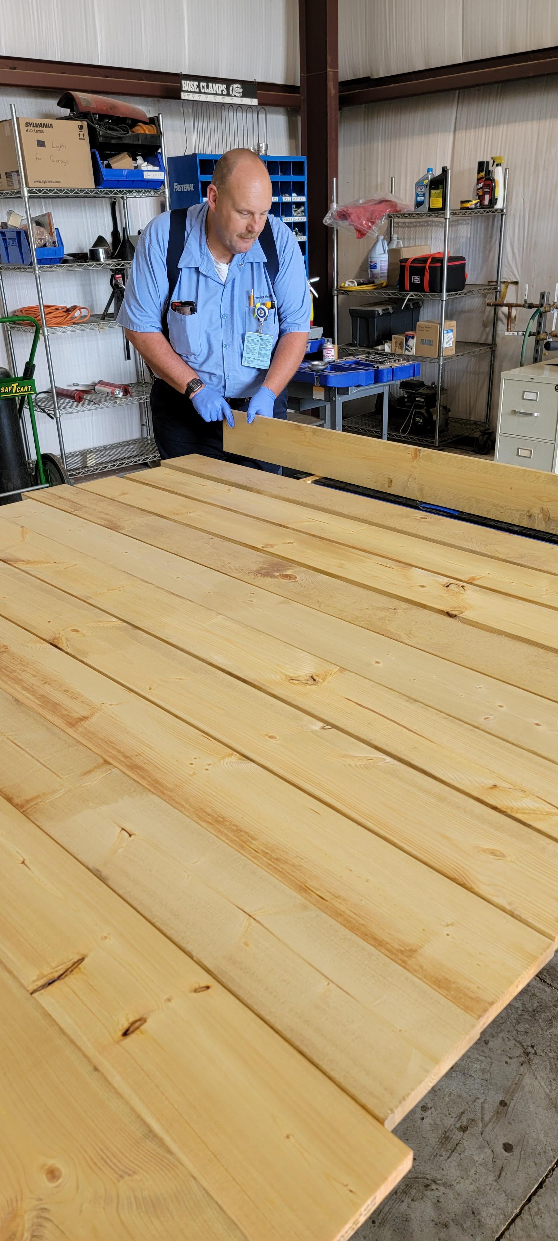 Larry Anglin, who works in the facilities department at Atrium Medical Center, works on some of the growth chart boards that will given out to military families Sunday at the hospital. SUBMITTED PHOTO