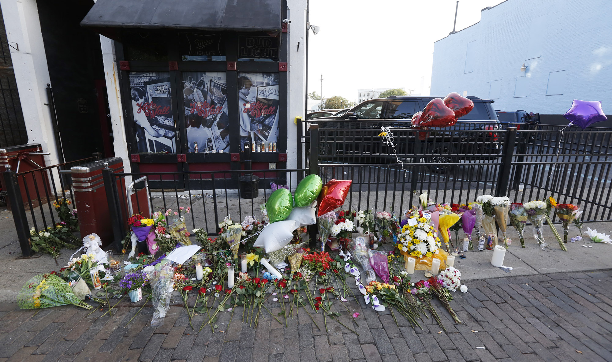 A memorial on the sidewalk of East Fifth Street in Dayton, seen here on Tuesday, has grown since the mass shooting early Sunday morning. TY GREENLEES / STAFF