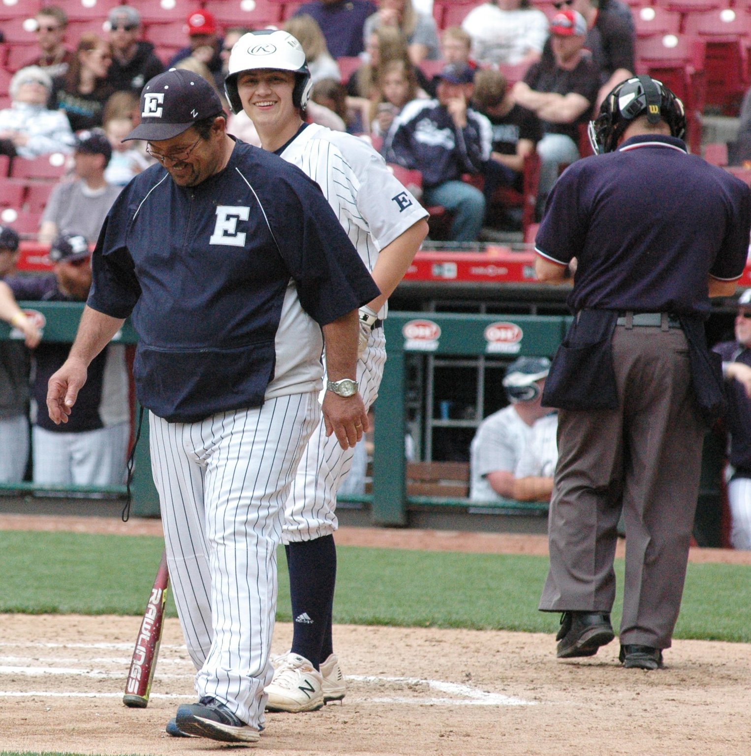 Edgewood coach Ralph Lunsford and Kody McCarley share a laugh at home plate during Saturday’s 2-1 Southwest Ohio Conference baseball victory over Harrison at Great American Ball Park in Cincinnati. The game was part of the Skyline Chili Reds Futures High School Showcase. RICK CASSANO/STAFF