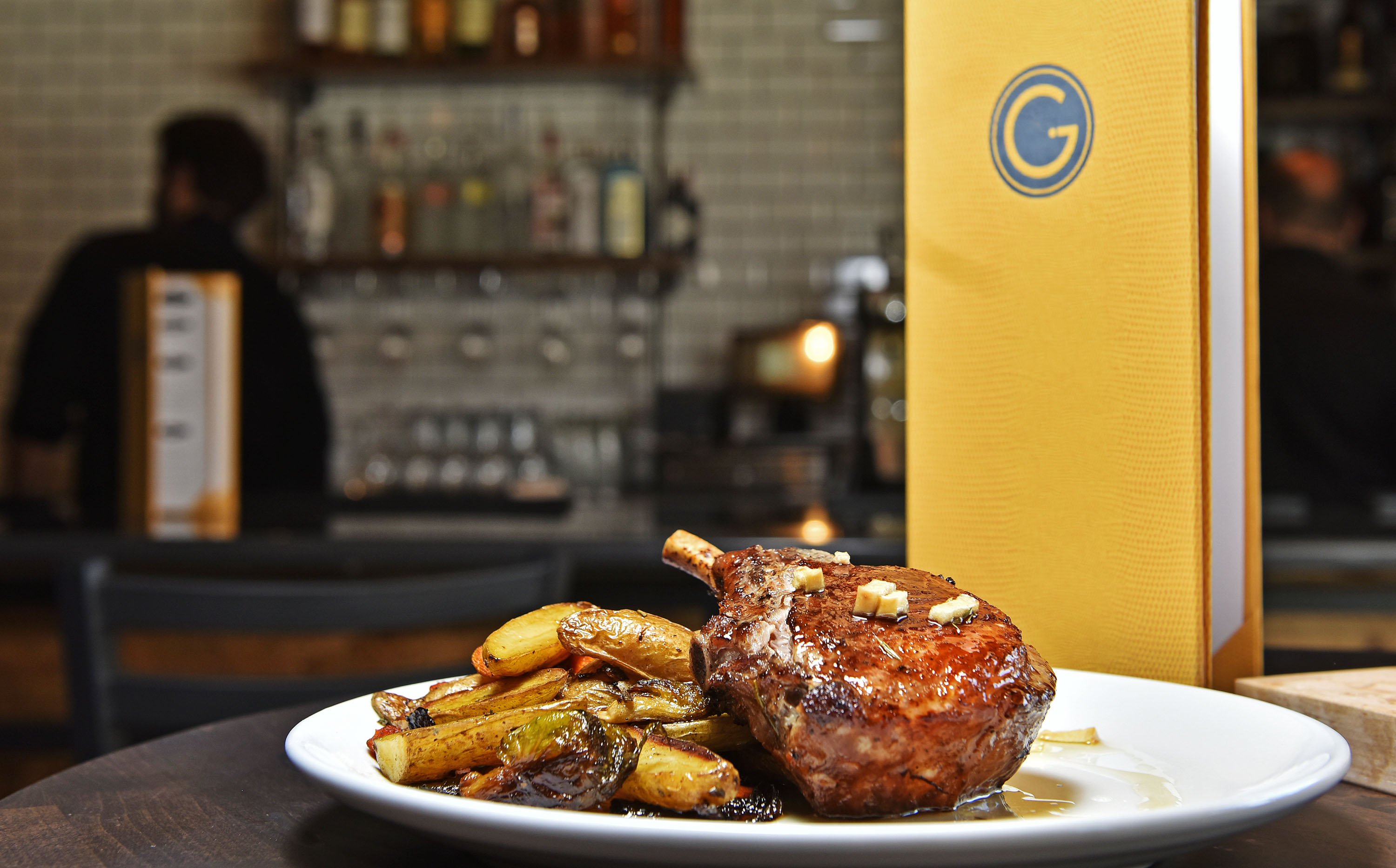 Gracie’s restaurant in Middletown. The menu is described as big city comfort food with items such as seared salmon, fried chicken, Berkshire pork chop and meatloaf.