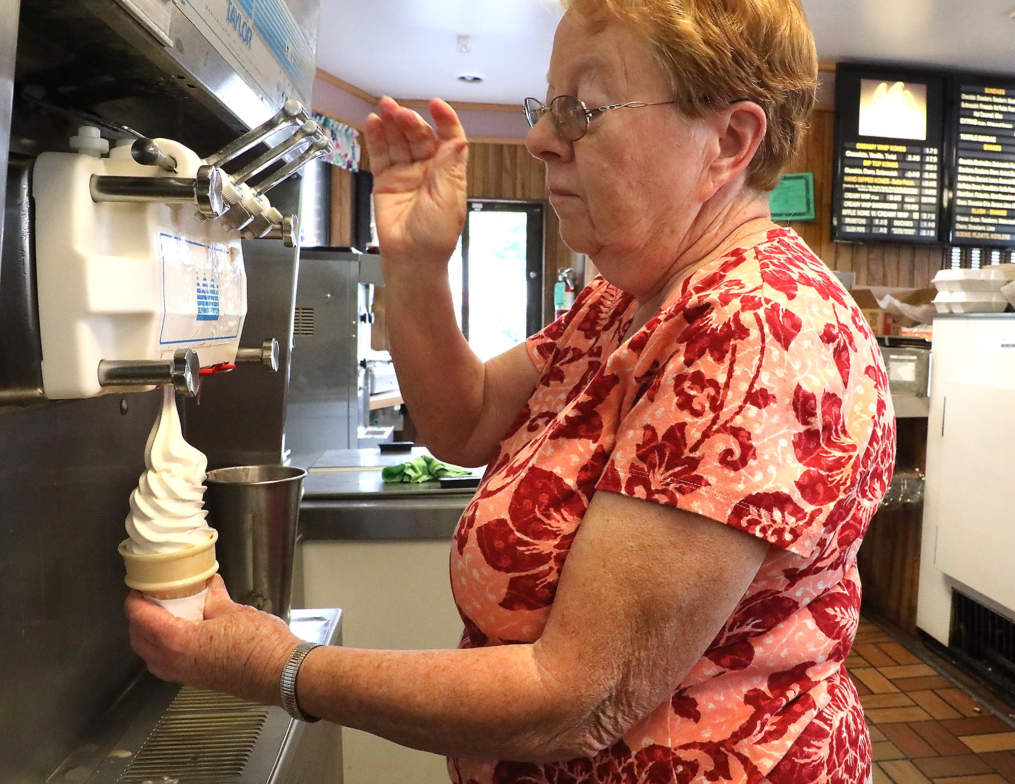 Marilyn Stanley, the owner of the Kone Korner, makes a softserve ice cream cone. BILL LACKEY/STAFF