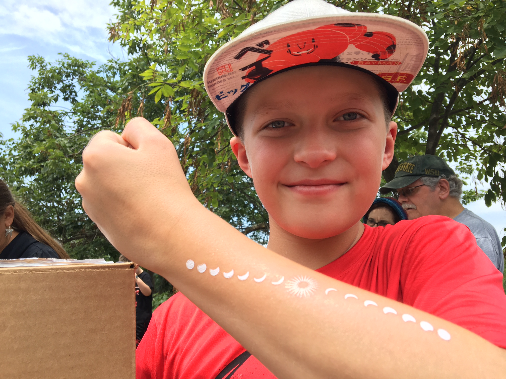 Connor Egloff, 11, of Dayton shows of a temporary tattoo showing a solar eclipse while viewing one Monday at the Boonshoft Museum of Discovery in Dayton. CHRIS STEWART / STAFF