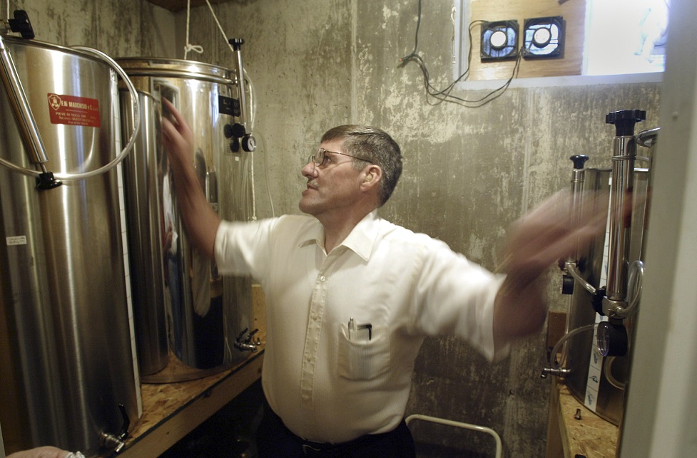 In this file photo from 2005, Jim Brandeberry looks over the fermentation tanks he used to make wine in what was then a climate-controlled basement room in his southern Clark County home.