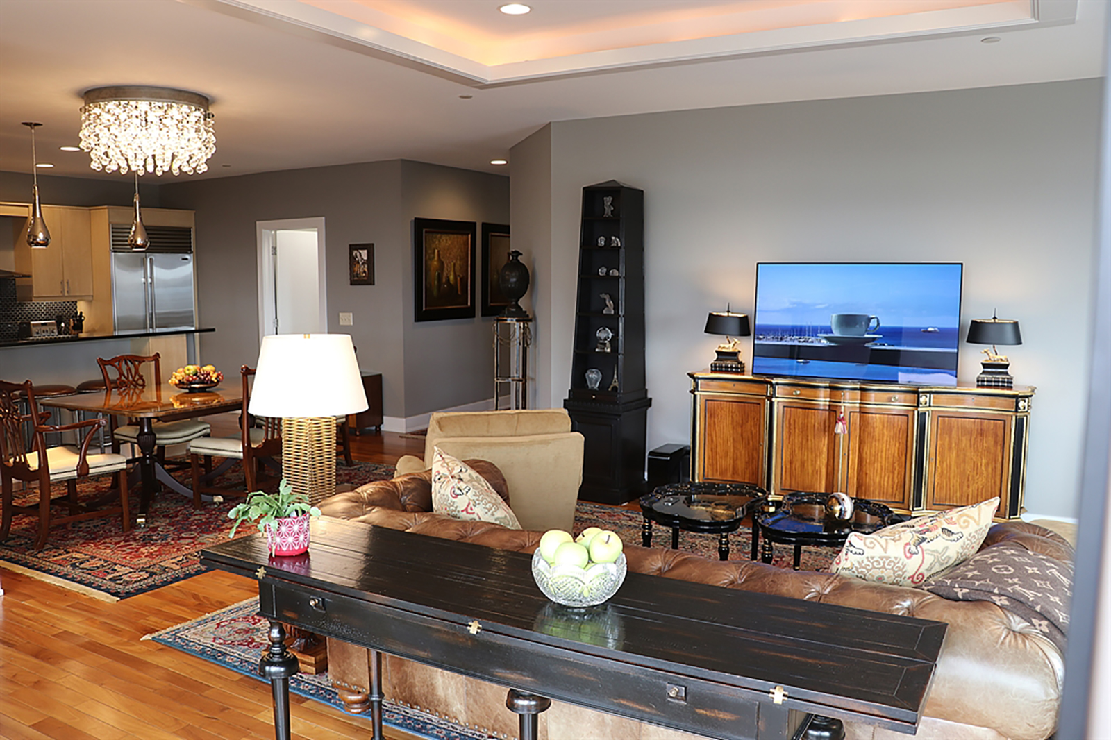 A tray ceiling has accent lighting and is above the living room. A crystal light fixture with dimmer is above the dining area. CONTRIBUTED PHOTO BY KATHY TYLER