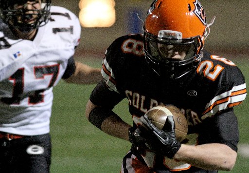 Coldwater wide receiver Caleb Siefring carries a reception in for a touchdown as Covington defensive back Kyler Deeter pursues during their playoff game at Welcome Stadium in Dayton Saturday, Nov. 17, 2012. E.L. Hubbard photography.