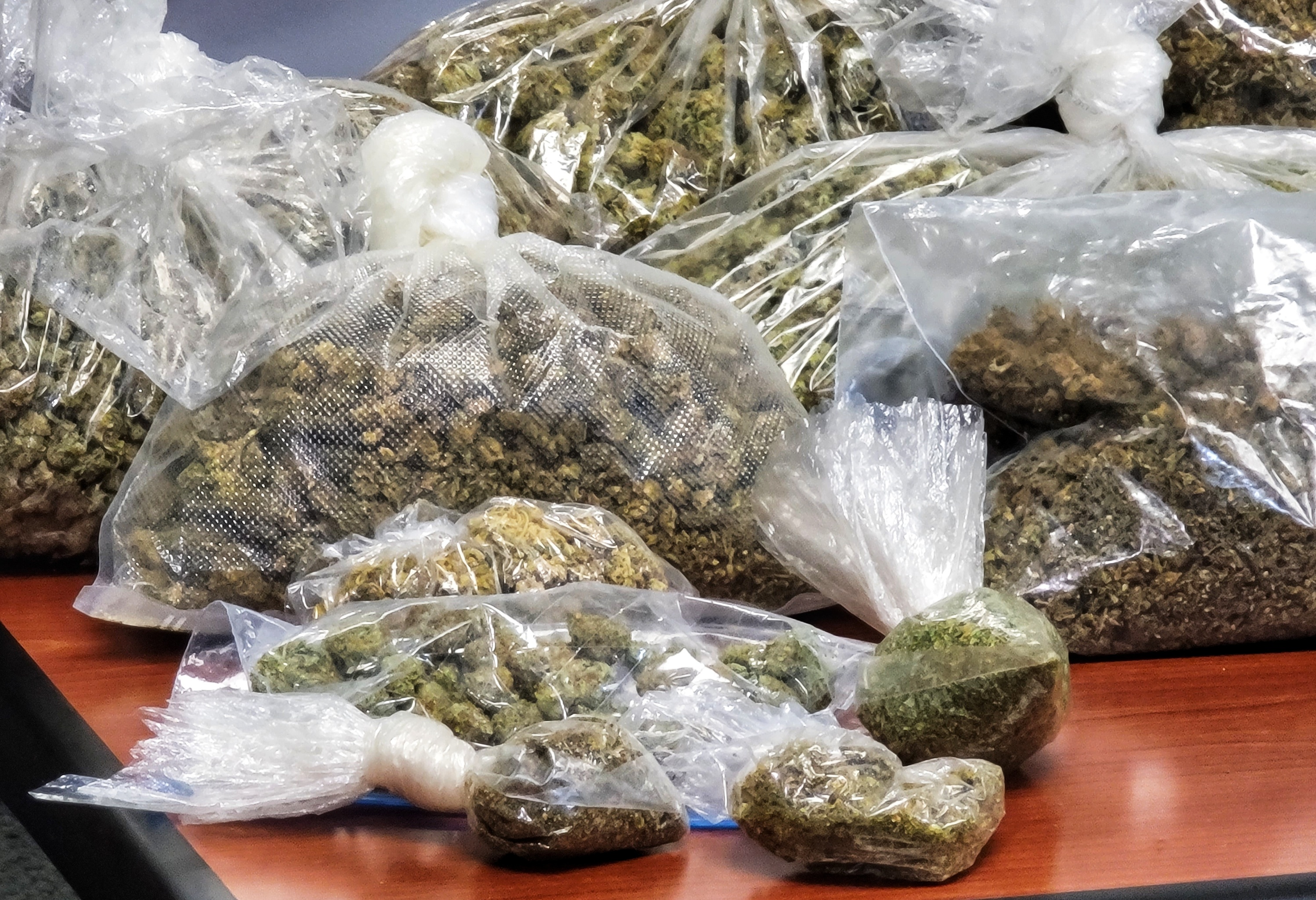 20 pounds of marijuan, two kilos of cocaine, guns and $75,000 in cash were seized from a Ridgelawn Avenue house in Hamilton Wednesday buy the Butler County B.U.R.N. unit. NICK GRAHAM/STAFF
