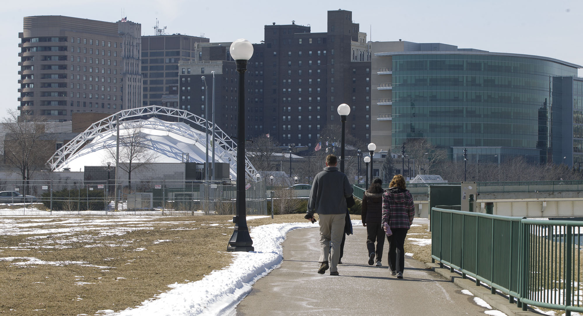 Workers from downtown Dayton walk back toward Riverscape from Deeds Point after a lunch hour walk. Staff photo by Ty Greenlees