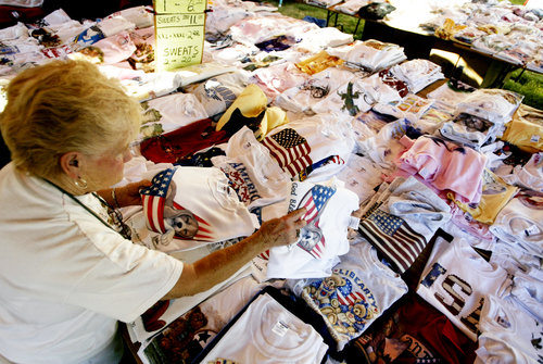 Barb Keehner of Eaton looks through hundreds of t-shirts at H&H Sales' booth during the Kiwanis Oktoberfest in West Alexandria on Sunday Oct. 12.