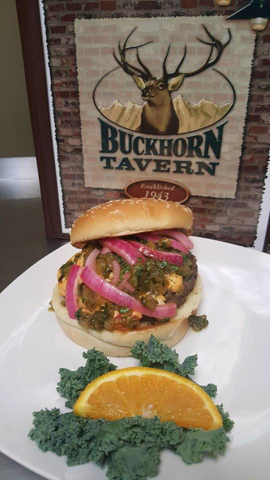 Buckhorn Tavern's Green Chile Burger, a half-pound ground beef, roasted green chiles and poblano peppers, pickled red onions. CONTRIBUTED