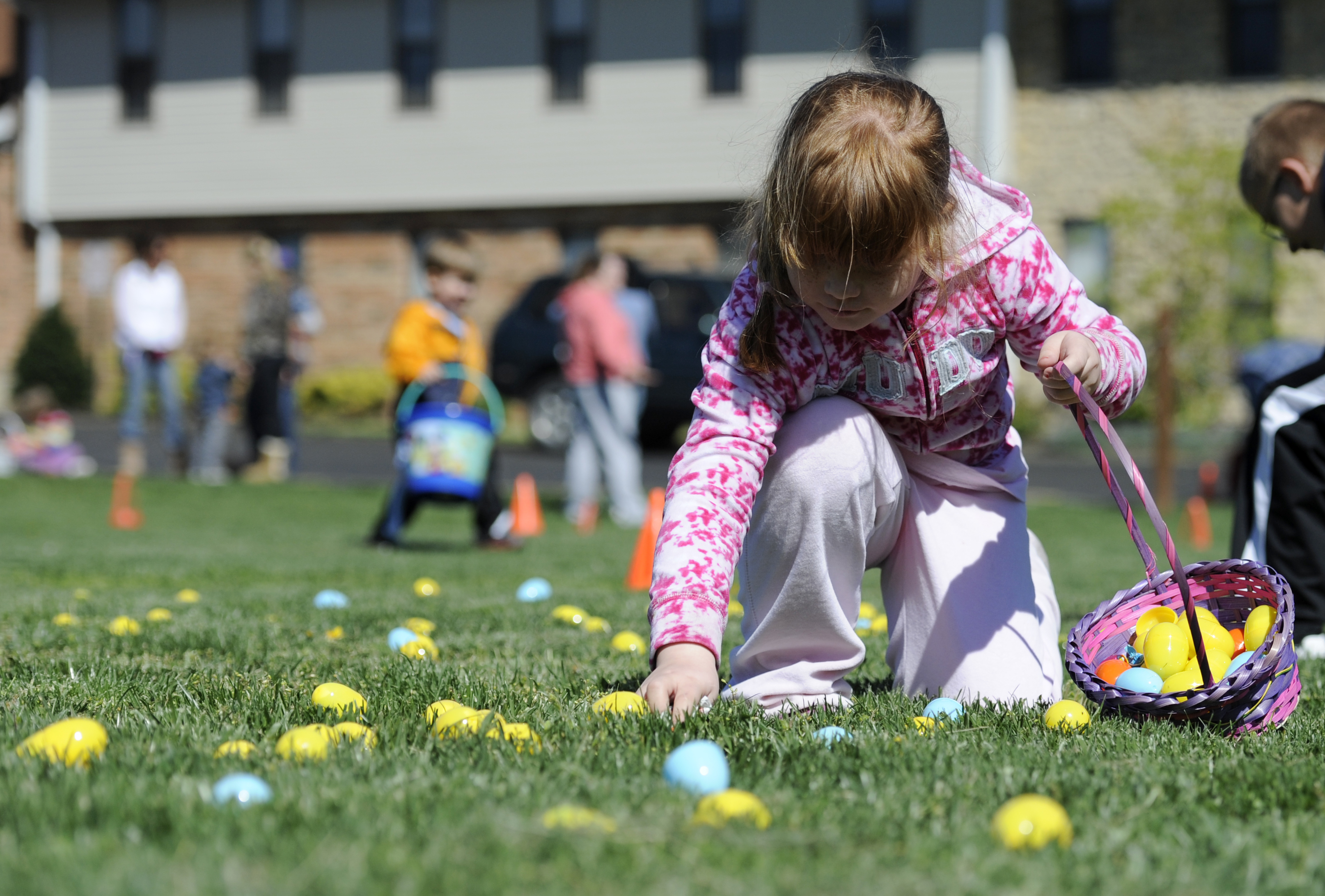 Danielle White, 7, of Hamilton, picks up eggs during the Easter Egg Hunt at Hamilton Church of God on Saturday, April 7, 2012. Staff photo by Samantha Grier