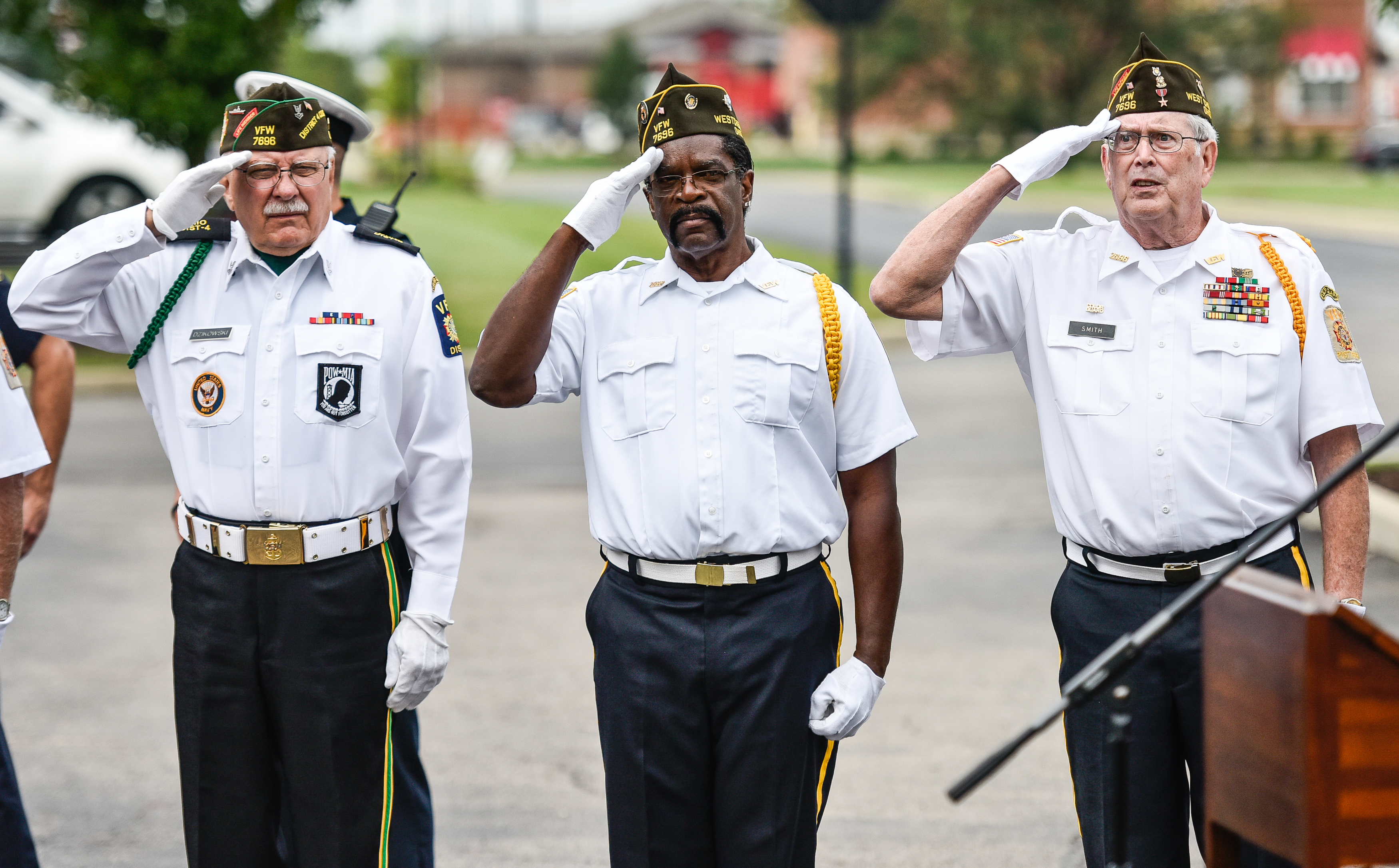 Ron Dzikowski, left, Donald Carter, middle, and Dave Smith, members of the West Chester VFW 7696 Color Guard, salute the flag during a 9/11 remembrance ceremony Tuesday, Sept. 11, 2018 at Chesterwood Village Senior Living Community on Tylersville Road in West Chester Township. NICK GRAHAM/STAFF