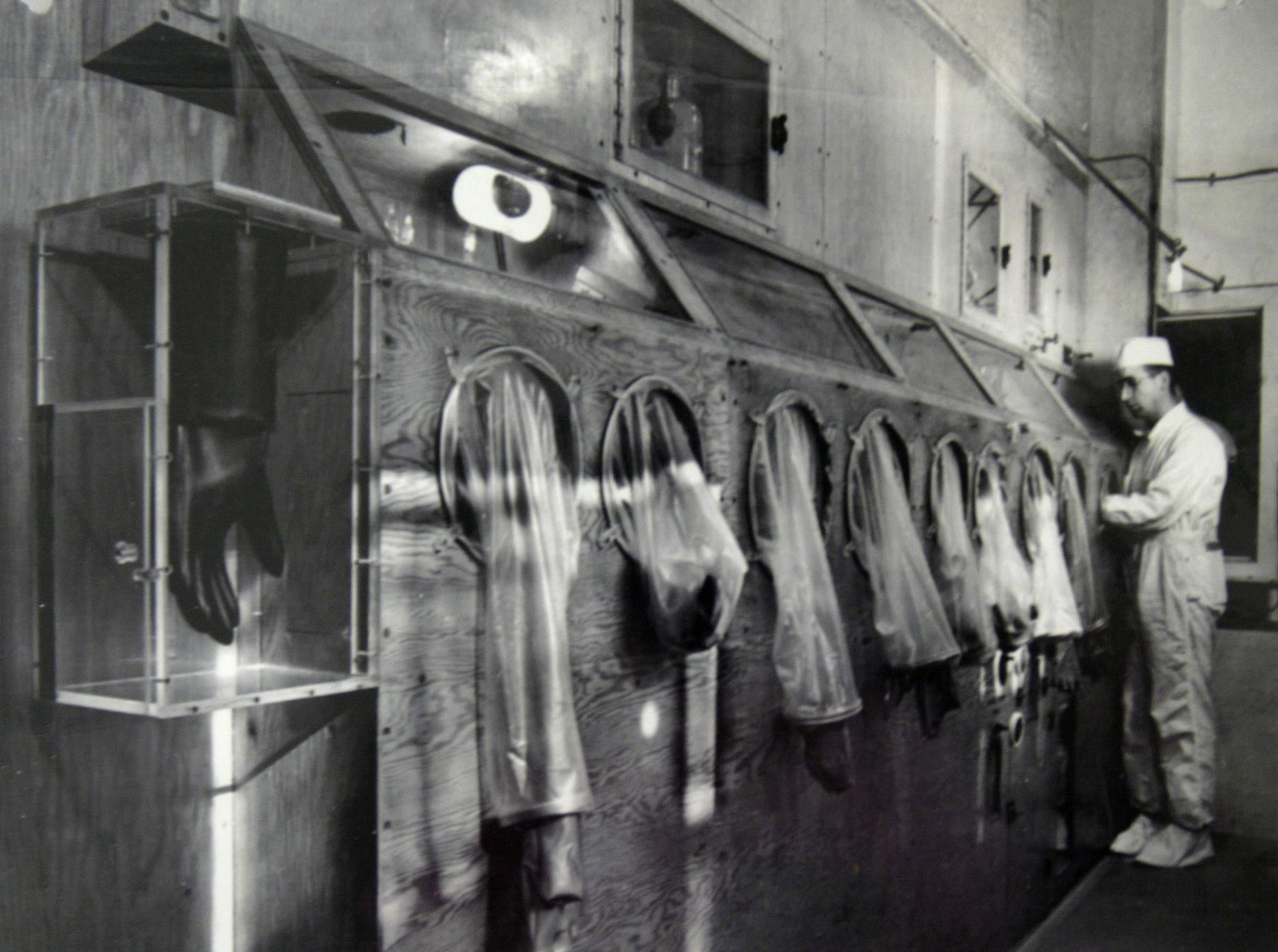 The Mound Museum in Miamisburg houses technology, worker information and photographs of its' history including this photograph taken in 1946 of a worker on the first glove box line processing polonium. Photo from the Mound Museum archive
