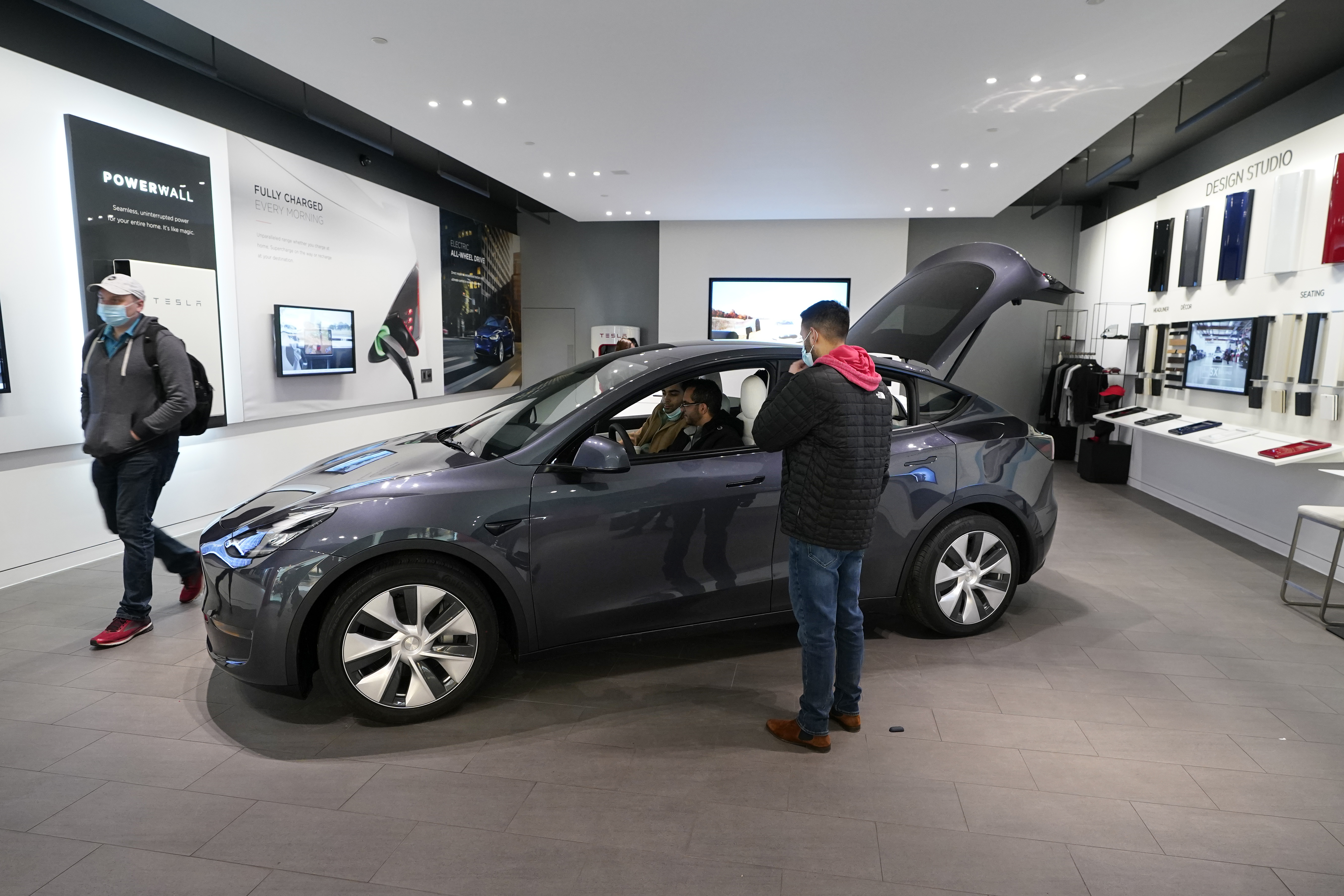 A Tesla Model Y Long Range is displayed at the Tesla Gallery on Feb. 24, 2021, in Troy, Mich. Opinion polls show that most Americans would consider an EV if it cost less, there were more charging stations along freeways, and if automakers offered a bigger variety of models. (AP Photo/Carlos Osorio)